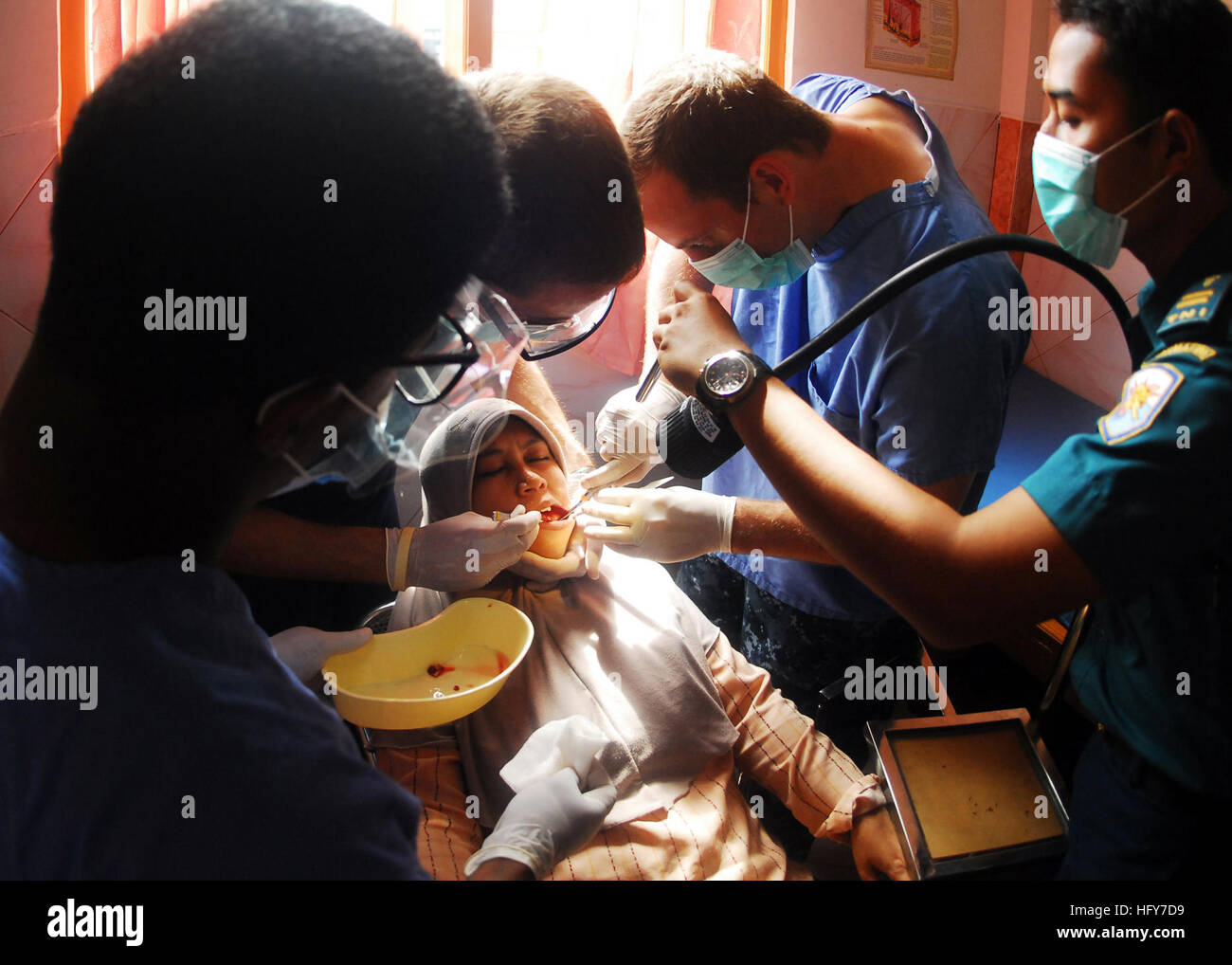 100527-N-0995C-062 WERU VILLAGE, Indonesia (May 27, 2010) U.S. and Indonesian navy dental officers extract a tooth from an Indonesian woman as part of a medical and dental civic action project conducted for Naval Engagement Activity Indonesia 2010. Naval Engagement Activity is part of the Cooperation Afloat Readiness and Training (CARAT) series of bilateral exercises held annually in Southeast Asia to strengthen relationships and enhance force readiness. Naval Engagement Activity is in its 16th year. (U.S. Navy photo by Mass Communication Specialist 2nd Class Eric J. Cutright/Released) US Navy Stock Photo