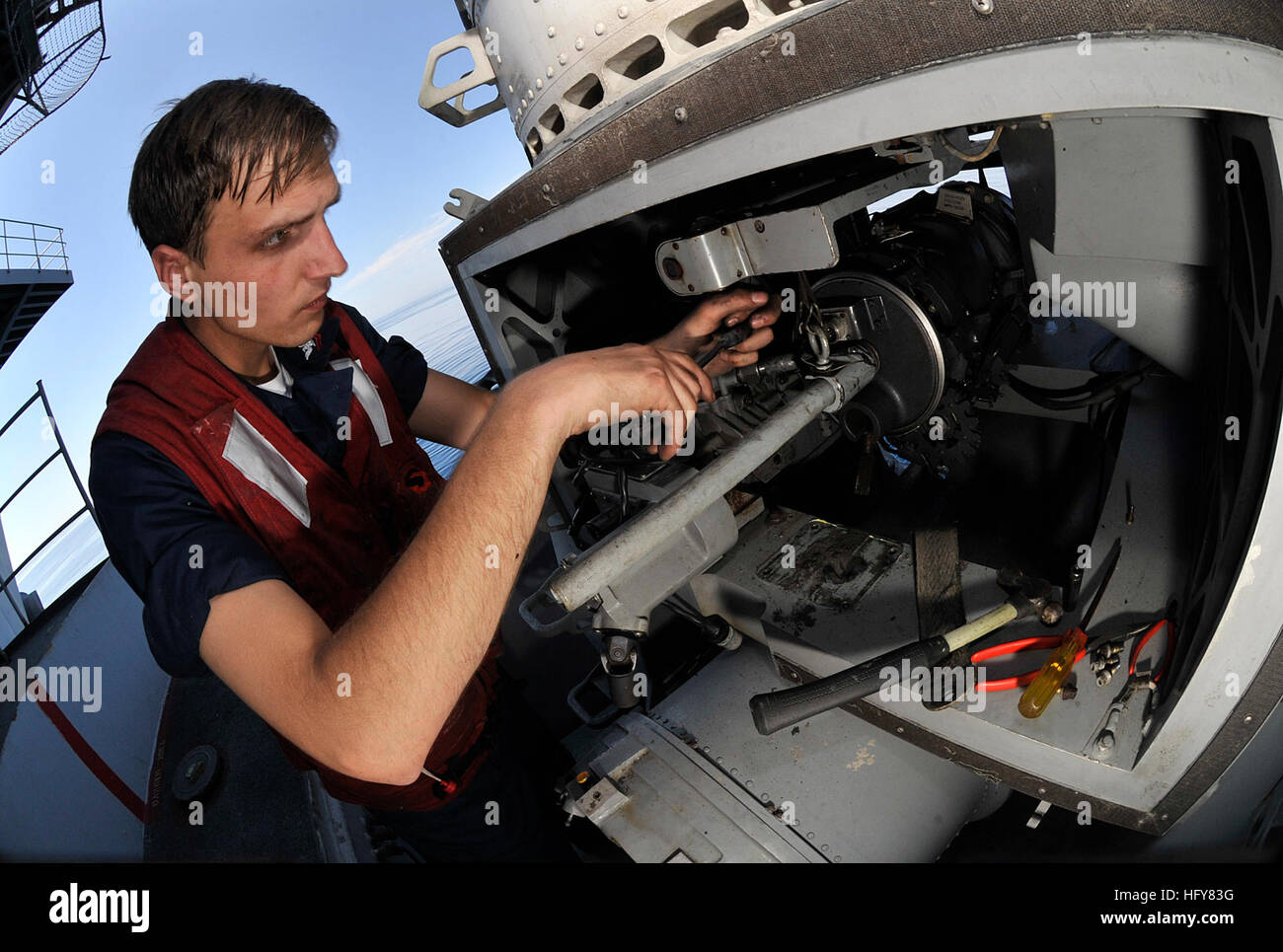 A Fire Controlman performs maintenance on the CIWS aboard USS Harry S ...