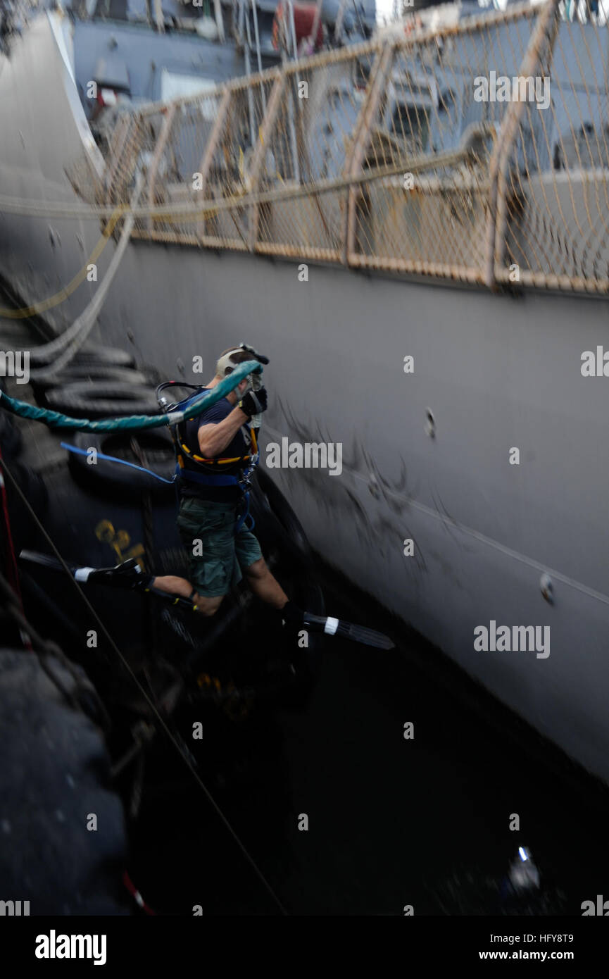 Navy diver performs a front step water entry to dive under USS The ...