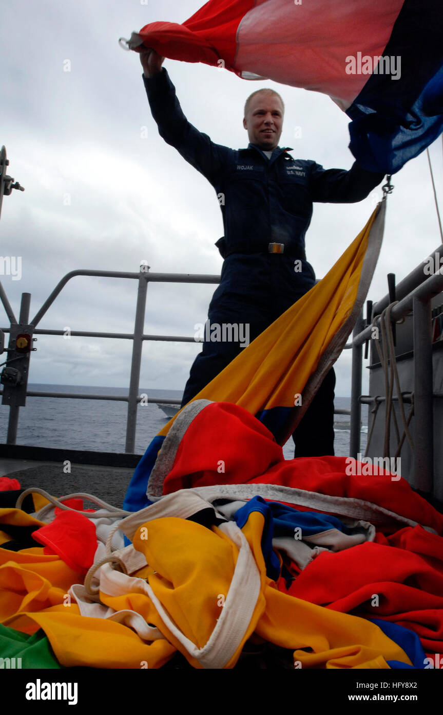 100619-N-6477M-687 PACIFIC OCEAN (June 19, 2010) Quartermaster 3rd Class Cameron Wojak prepares to stow away signal flags after a flag hoist drill aboard the amphibious transport dock ship USS Cleveland (LPD 7). Cleveland is en route to the Hawaiian operating area to support Rim of the Pacific (RIMPAC) exercises, a biennial, multi-national exercise designed to strengthen regional partnerships and improve multi-national interoperability. (U.S. Navy photo by Mass Communication Specialist 1st Class Eli J. Medellin/Released) US Navy 100619-N-6477M-687 Quartermaster 3rd Class Cameron Wojak prepares Stock Photo