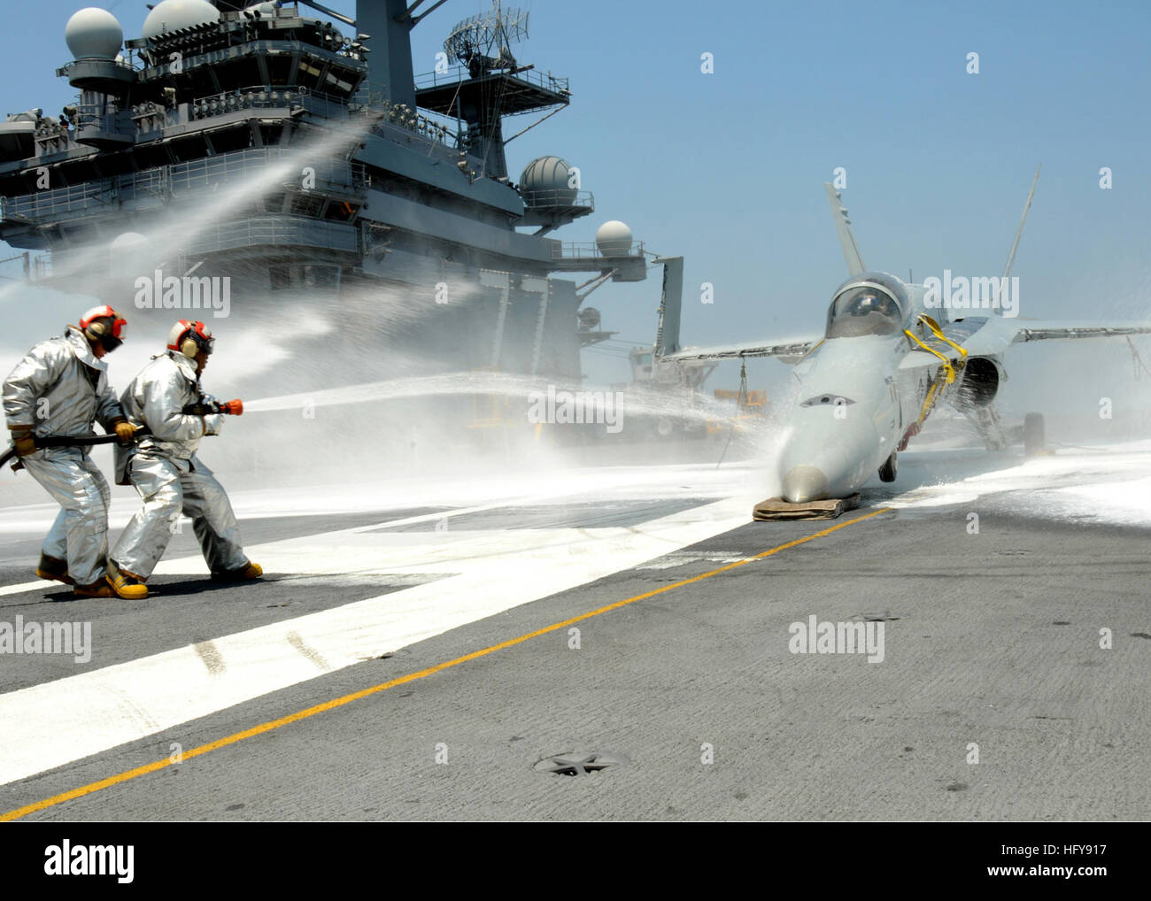 Air department Sailors from the crash and salvage division spray water ...