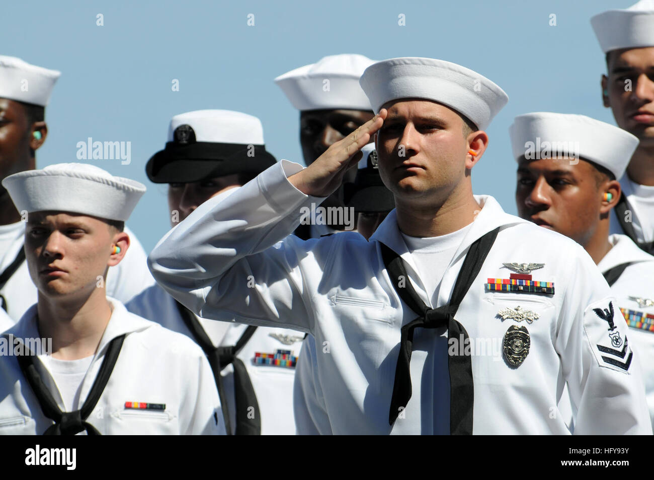 Petty Officer 2nd Class Joseph Churan, master-at -arms, assigned to the 'Black Knights' of Helicopter Anti-Submarine Squadron 4, salutes as remains of military personnel are laid to rest at sea during a burial at sea ceremony on elevator four of the aircraft carrier USS Ronald Reagan. A burial at sea is a time honored Navy tradition honoring deceased veterans and their spouses. Ronald Reagan is currently underway in the Pacific Ocean conducting Tailored Ships Training Availability. USS Ronald Reagan DVIDS294325 Stock Photo