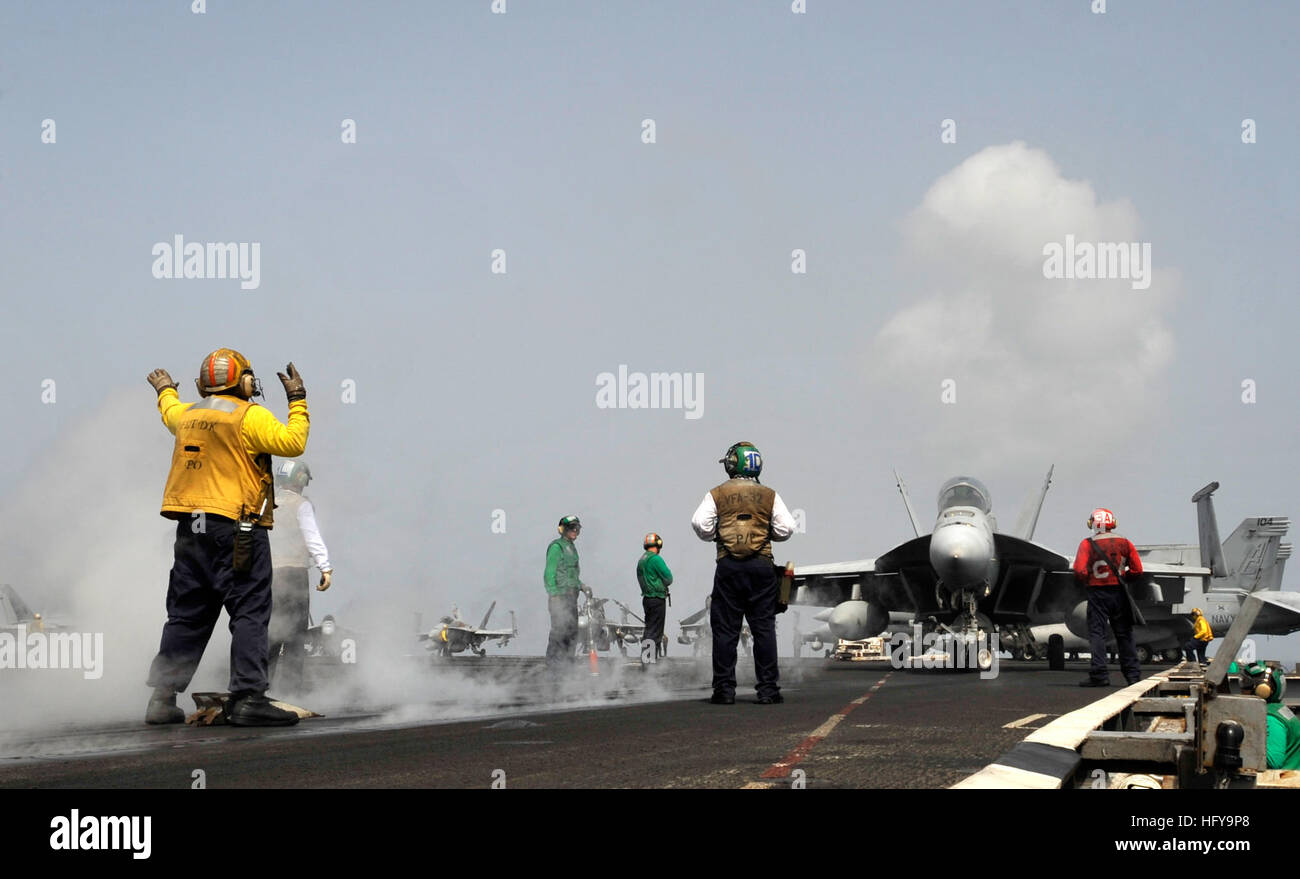100704-N-6003P-032 U.S. 5TH FLEET AREA OF RESPONSIBILITY (July 4, 2010) A plane director guides an F/A-18 Hornet onto the catapult for take-off aboard the aircraft carrier USS Harry S. Truman (CVN 75). Harry S. Truman is deployed as part of the Harry S. Truman Carrier Strike Group supporting maritime security operations and theater security cooperation efforts in the U.S. 5th Fleet area of responsibility. (U.S. Navy photo by Mass Communication Specialist 2nd Class Kilho Park/Released) US Navy 100704-N-6003P-032 A plane director guides an F-A-18 Hornet onto the catapult for take-off aboard the  Stock Photo