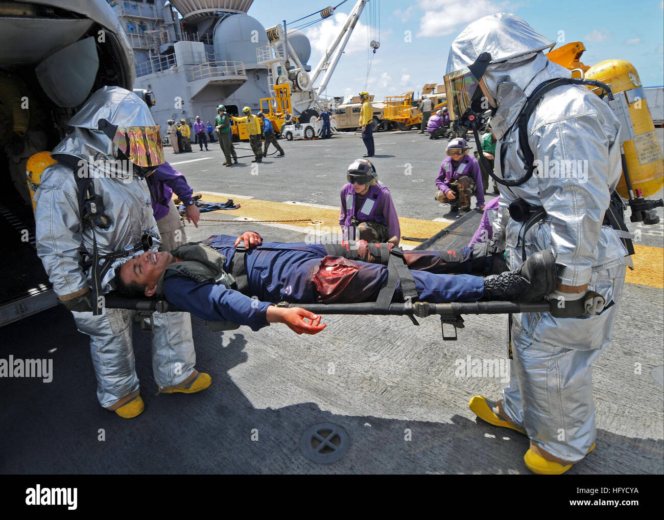 A crash and salvage team aboard USS Iwo Jima (LHD 7) removes an injured ...