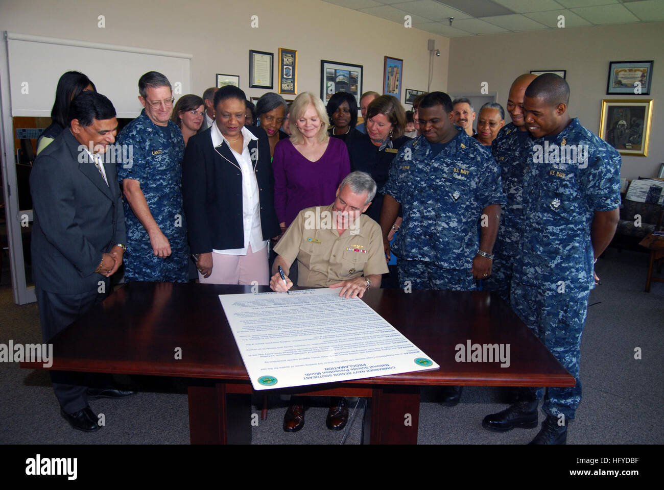 100908-N-5165S-007   JACKSONVILLE, Fla. (Sept. 8, 2010) Rear Adm. Tim Alexander, commander of Navy Region Southeast, signs a proclamation making September Suicide Prevention Month during a ceremony in the commander's office. Looking on are members of the Navy Region Southeast and installation staffs. (U.S. Navy photo by Twilla Smith/Released) US Navy 100908-N-5165S-007 Rear Adm. Tim Alexander, commander of Navy Region Southeast, signs a proclamation making September Suicide Prevention Mo Stock Photo