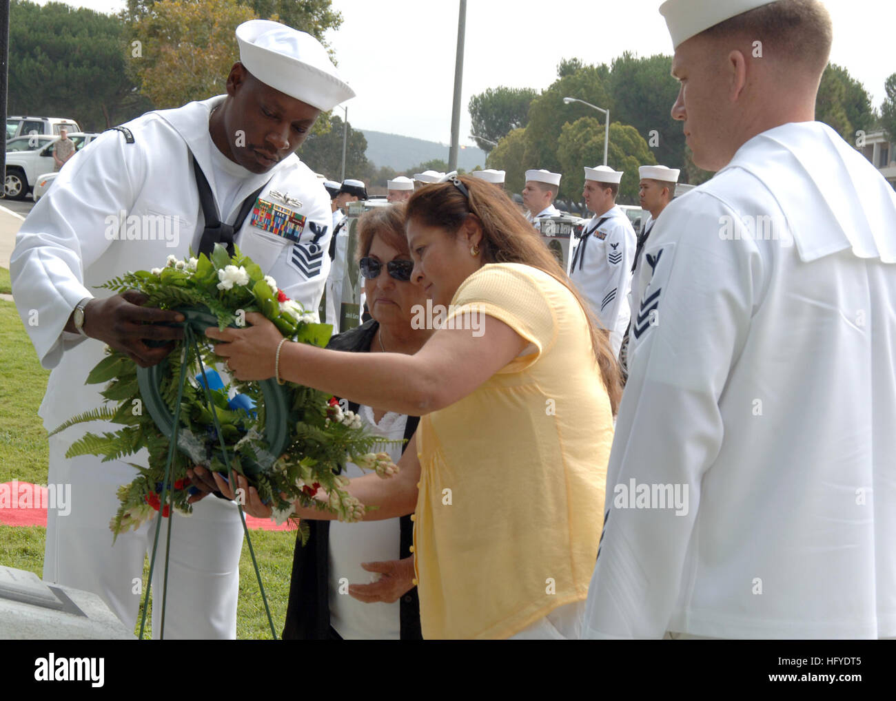100917-N-3931M-174 CAMP PENDLETON, Calif. (Sept. 17, 2010) Esmeralda Denton, center left, wife of Hospital Corpsman 3rd Class Manuel Reyes Denton, and their daughter, Barbara Denton-Brownell, place a wreath on the Prisoner of War and Missing in Action Memorial at Naval Hospital Camp Pendleton during a service of remembrance on National POW/MIA Recognition Day. Assisting Denton are Petty Officers 1st Class Walter Hooks, left, and Alex Isenhour. (U.S. Navy photo by Mass Communication Specialist 1st Class Michael R. McCormick/Released) US Navy 100917-N-3931M-174 Family members place a wreath on t Stock Photo