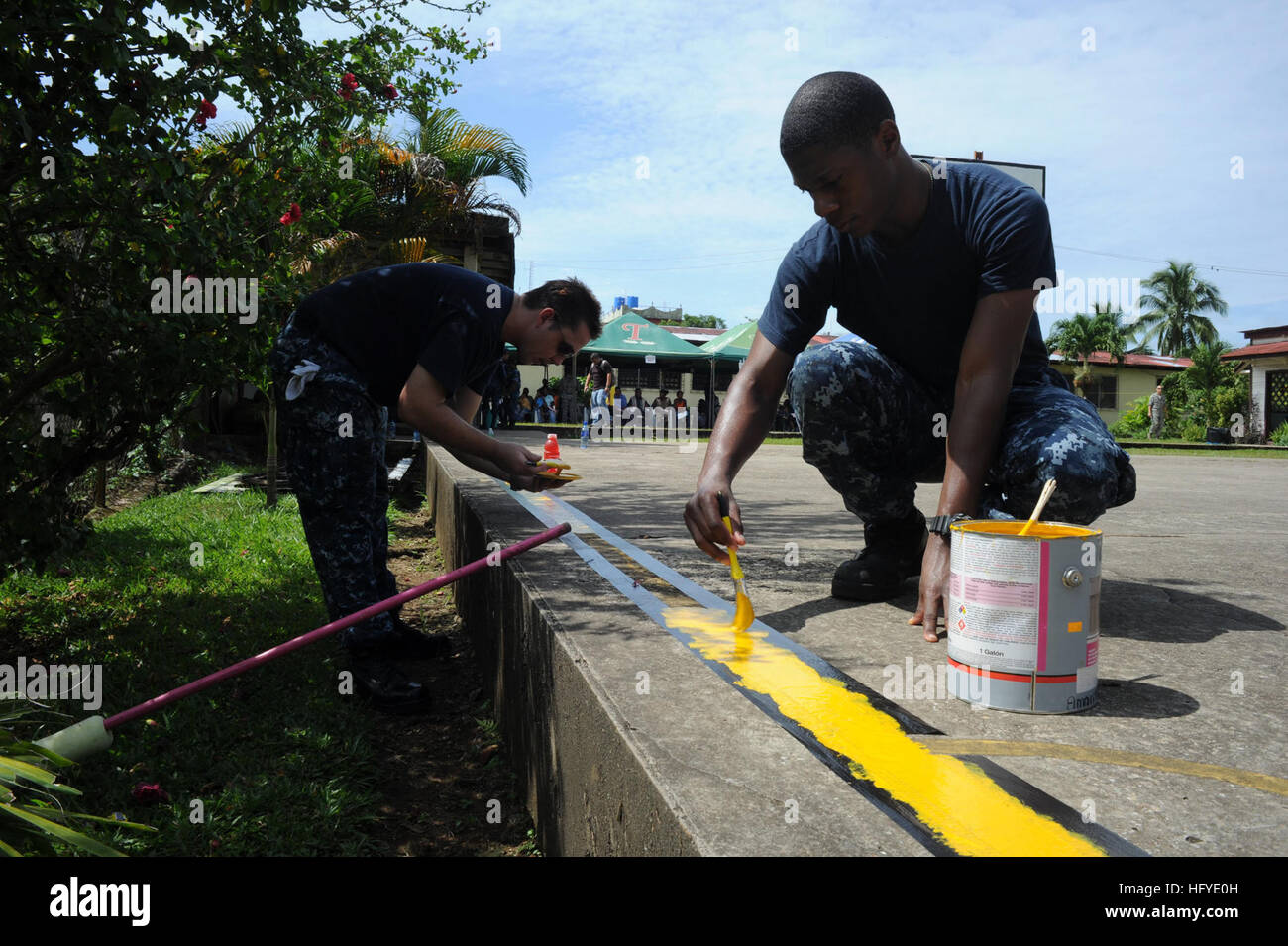 100920-N-9964S-048 BLUEFIELDS, Nicaragua (Sept. 20, 2010) Quartermaster 2nd Class Shawn Dekle and Fireman Christopher Thomas paint a yellow line on a basketball court during a community service project at Las Carmeles Park. The assigned medical and engineering staff embarked aboard Iwo Jima are working with partner nations to provide medical, dental, veterinary, and engineering assistance in several nations to improve mutual understanding of current medical issues and technology. (U.S. Navy photo by Mass Communication Specialist 1st Class Christopher B. Stoltz/Released) US Navy 100920-N-9964S- Stock Photo