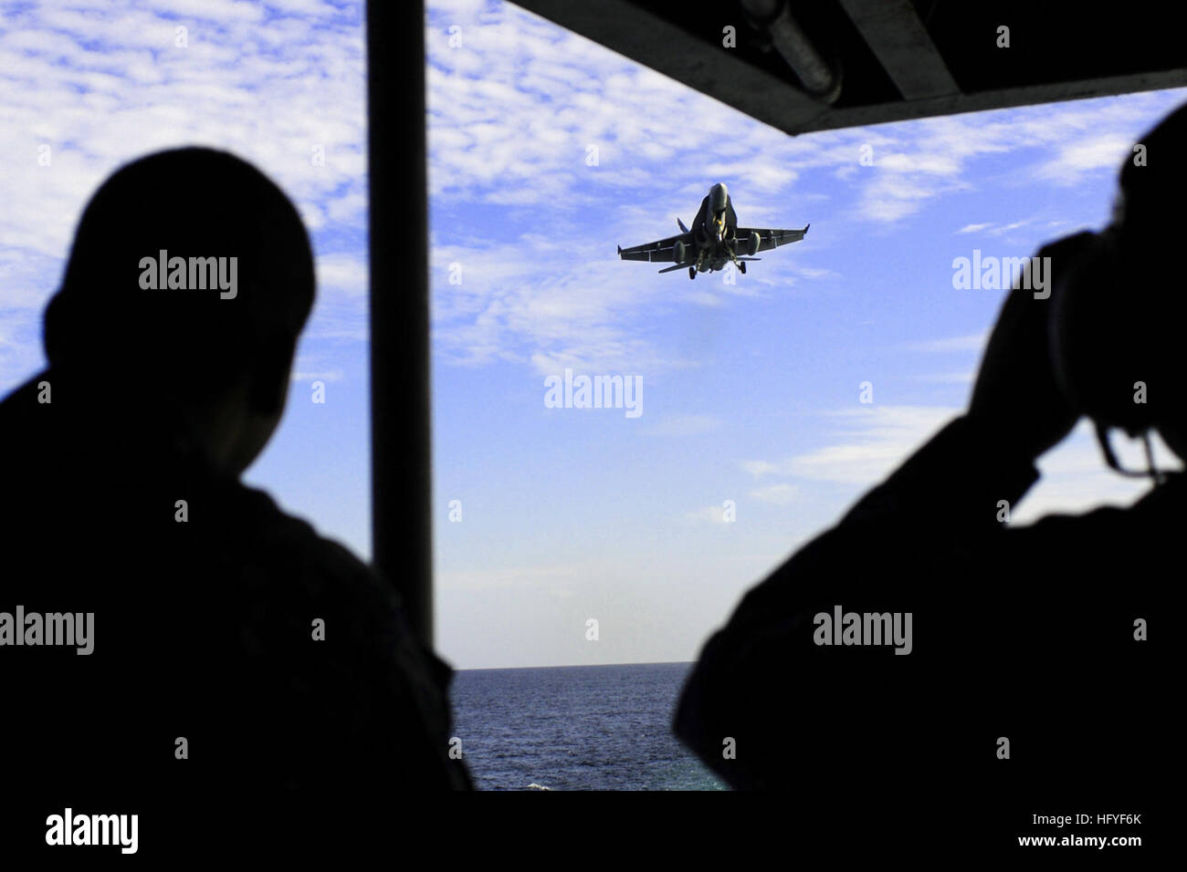 An F/A-18C Hornet from the Death Rattlers of Marine Strike Fighter Squadron 323 makes final adjustments to its approach above the flight deck of the nuclear-powered aircraft carrier USS Ronald Reagan.  Ronald Reagan is capable of landing one aircraft every minute on its 800-foot flight deck. Ronald Reagan and its embarked squadrons are currently underway conducting carrier qualifications in preparation for an upcoming deployment. (U.S. Navy photo/Petty Officer 3nd Class Alexander Tidd) USS Ronald Reagan DVIDS331884 Stock Photo