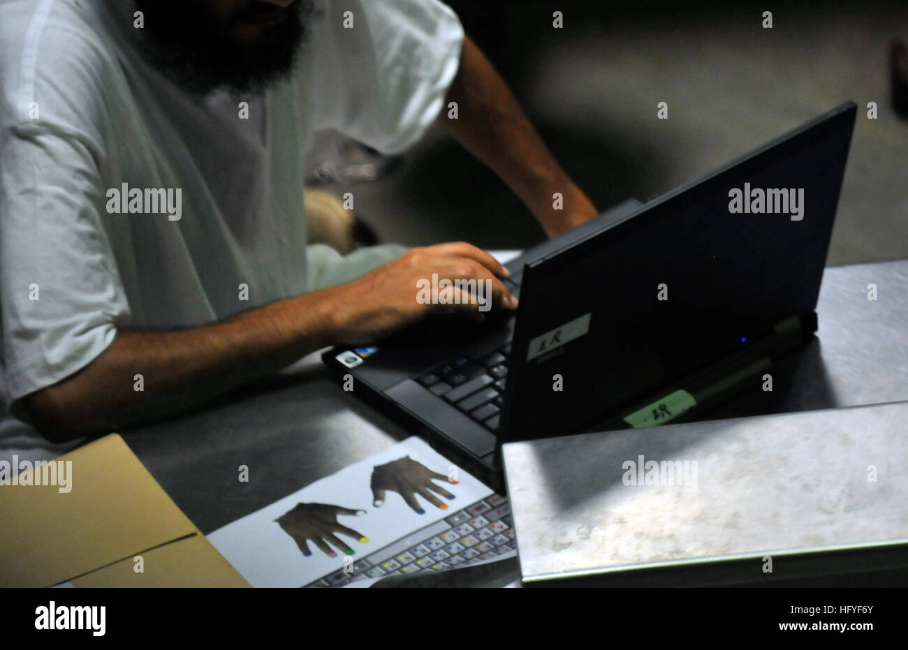 101020-N-3887D-086 GUANTANAMO BAY, Cuba (Oct. 20, 2010) A detainee learns typing skills during a life skills class in Camp Six at Joint Task Force Guantanamo. The class provides detainees with laptop computers with software that enhances literacy and teaches health and finance. (U.S. Navy photo by Mass Communication Specialist 2nd Class Elisha Dawkins/Released) US Navy 101020-N-3887D-086 A detainee learns typing skills during a life skills class in Camp Six at Joint Task Force Guantanamo Stock Photo