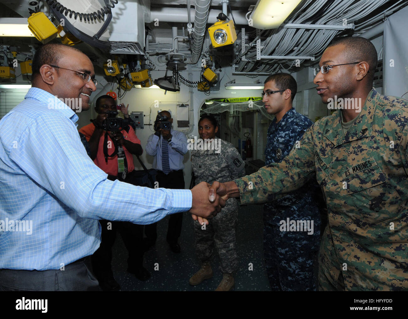 101025-N-7680E-073 CARIBBEAN SEA (Oct. 25, 2010) President of Guyana Bharat Jagdeo meets Cpl. John Eversley, a Guyanese-American Marine embarked aboard the multi-purpose amphibious assault ship USS Iwo Jima (LHD 7). Iwo Jima is anchored off of the coast of Guyana supporting the Continuing Promise 2010 humanitarian civic assistance mission. The assigned medical and engineering staff embarked aboard Iwo Jima is working with partner nations to provide medical, dental, veterinary, and engineering assistance in eight countries. (U.S. Navy photo by Mass Communication Specialist 2nd Class Zane Ecklun Stock Photo