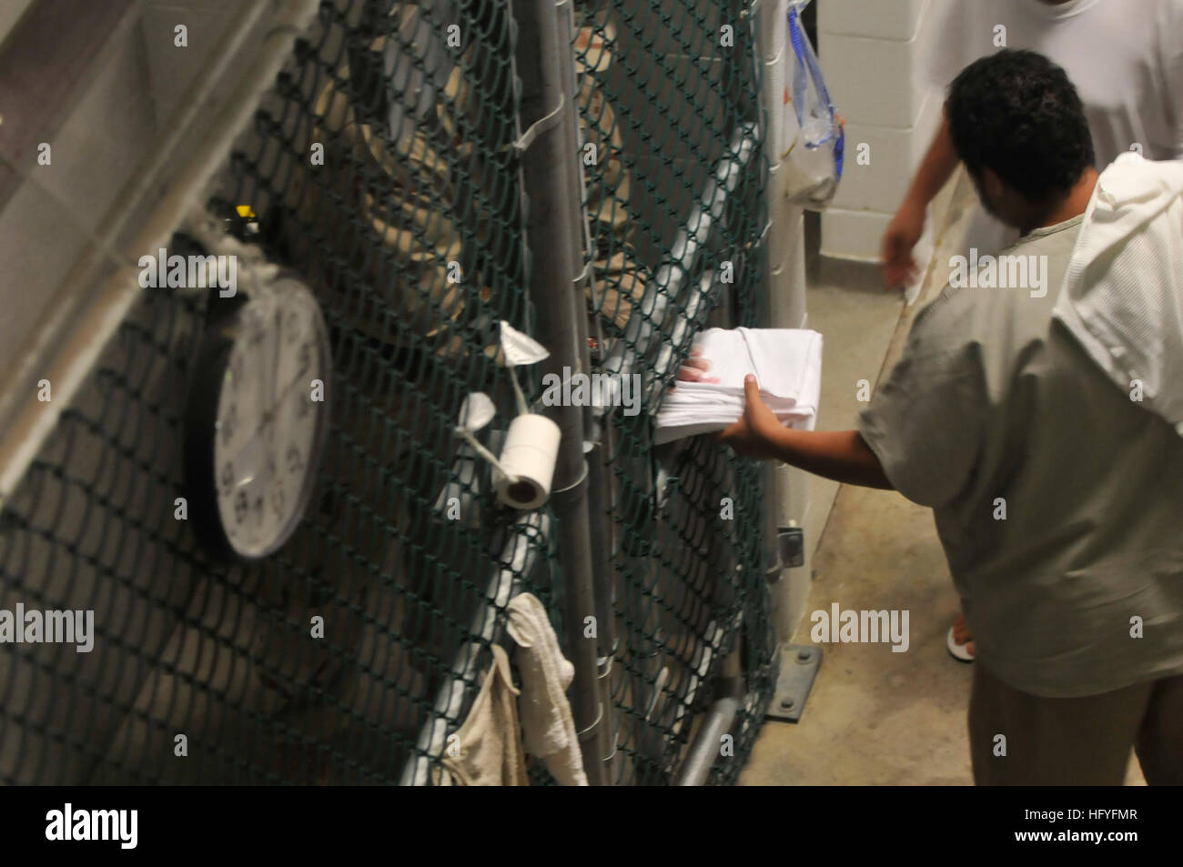 101028-N-3887D-047 GUANTANAMO BAY, Cuba (Oct. 28, 2010) A detainee receives new linens in the communal area of Camp Six at Joint Task Force Guantanamo. (U.S. Navy photo by Mass Communication Specialist 2nd Class Elisha Dawkins/Released) US Navy 101028-N-3887D-047 A detainee receives new linens in the communal area of Camp Six at Joint Task Force Guantanamo Stock Photo