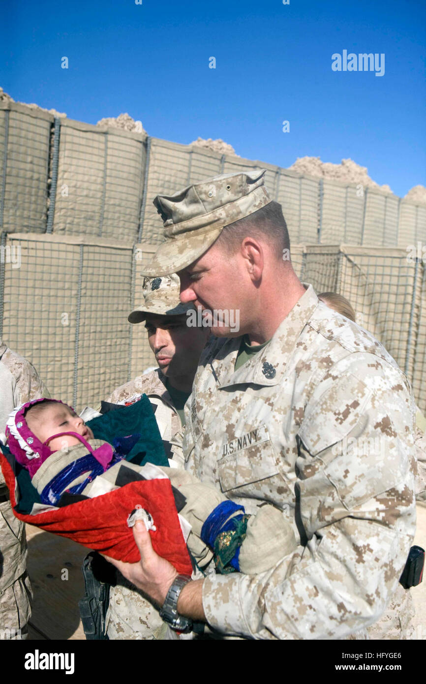 101114-M-1880C-046 MARJAH, Afghanistan (Nov. 14, 2010) Chief Petty Officer Robert Davis, assigned to 2nd Battalion, 6th Marine Regiment, holds an infant that was brought to the Afghan National Army medical outreach in Marjah, Afghanistan, to receive a physical exam. Sixth Marine Regiment is deployed in Helmand Province supporting International Security Assistance Force. (U.S. Marine Corps photo by Lance Cpl. Shawn P. Coover/Released) US Navy 101114-M-1880C-046 Chief Petty Officer Robert Davis, assigned to 2nd Battalion, 6th Marine Regiment, holds an infant that was brought to th Stock Photo