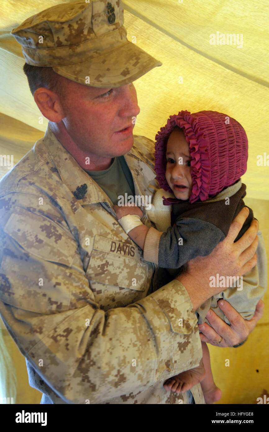 101114-M-1880C-172 MARJAH, Afghanistan (Nov. 14, 2010) Chief Petty Officer Robert Davis, assigned to 2nd Battalion, 6th Marine Regiment, holds an infant that was brought to the Afghan National Army medical outreach in Marjah, Afghanistan. Sixth Marine Regiment is deployed in Helmand Province supporting International Security Assistance Force. (U.S. Marine Corps photo by Lance Cpl. Shawn P. Coover/Released) US Navy 101114-M-1880C-172 Chief Petty Officer Robert Davis, assigned to 2nd Battalion, 6th Marine Regiment, holds an infant that was brought to th Stock Photo