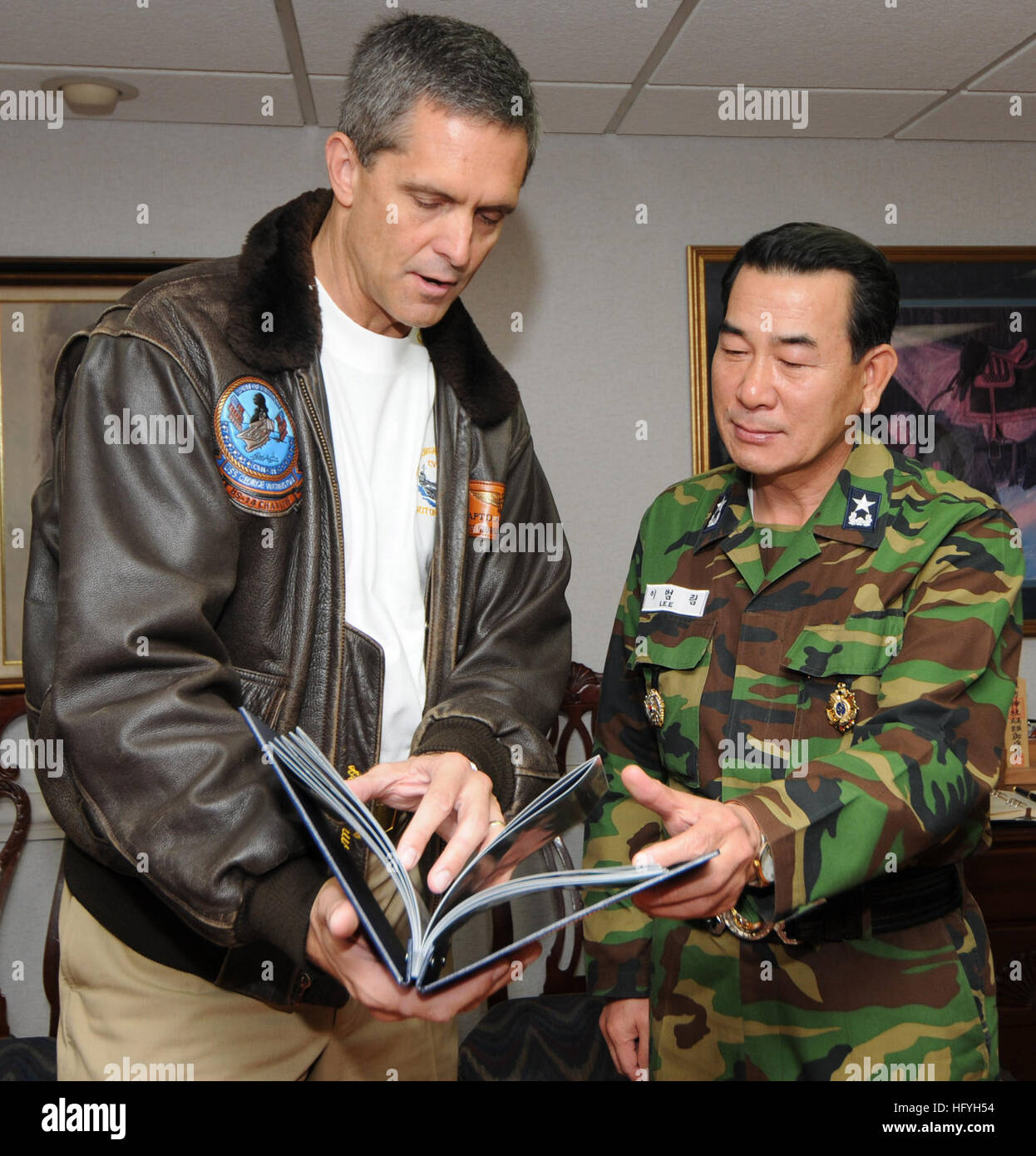 Capt David Lausman Commanding Officer Of The Aircraft Carrier Uss George Washington Presents A Photo Album To Republic Of Korea Navy Adm Beon Rim Lee George Washington Is In The Waters West Of