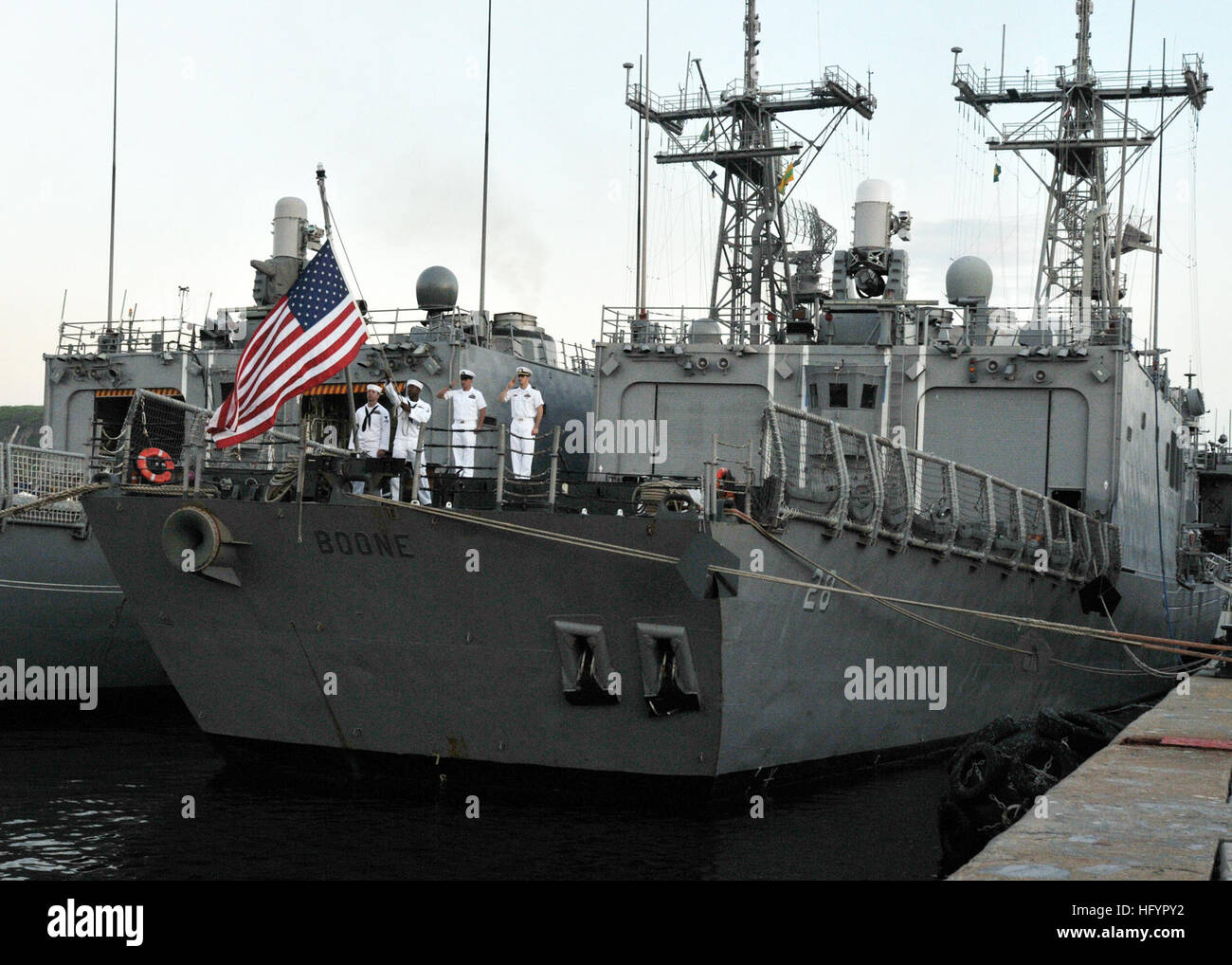 110501-N-NL541-227 RIO DE JANEIRO, Brazil (May 1, 2011) The color guard of the guided-missile frigate USS Boone (FFG 28) lowers the national ensign during evening colors in Rio De Janeiro, Brazil. Boone is deployed supporting Southern Seas 2011. (U.S. Navy photo by Mass Communication Specialist 3rd Class Stuart Phillips/Released) US Navy 110501-N-NL541-227 The color guard of the guided-missile frigate USS Boone (FFG 28) lowers the national ensign during evening colors Stock Photo