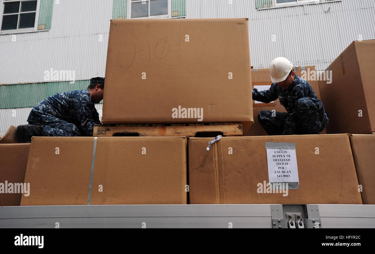 110510-N-6720T-014 YOKOSUKA, Japan (May 10, 2011) Sailors aboard the aircraft carrier USS George Washington (CVN 73) place boxes of blankets donated by George Washington Sailors and their families onto a flatbed truck outside one of George Washington's warehouses. The blankets will be delivered to areas in Japan hit hardest by a 9.0 magnitude earthquake and subsequent tsunami that struck Japan on March 11. George Washington is the Navy's only permanently forward-deployed aircraft carrier. (U.S. Navy photo by Mass Communication Specialist 3rd Class Adam K. Thomas/Released) US Navy 110510-N-6720 Stock Photo