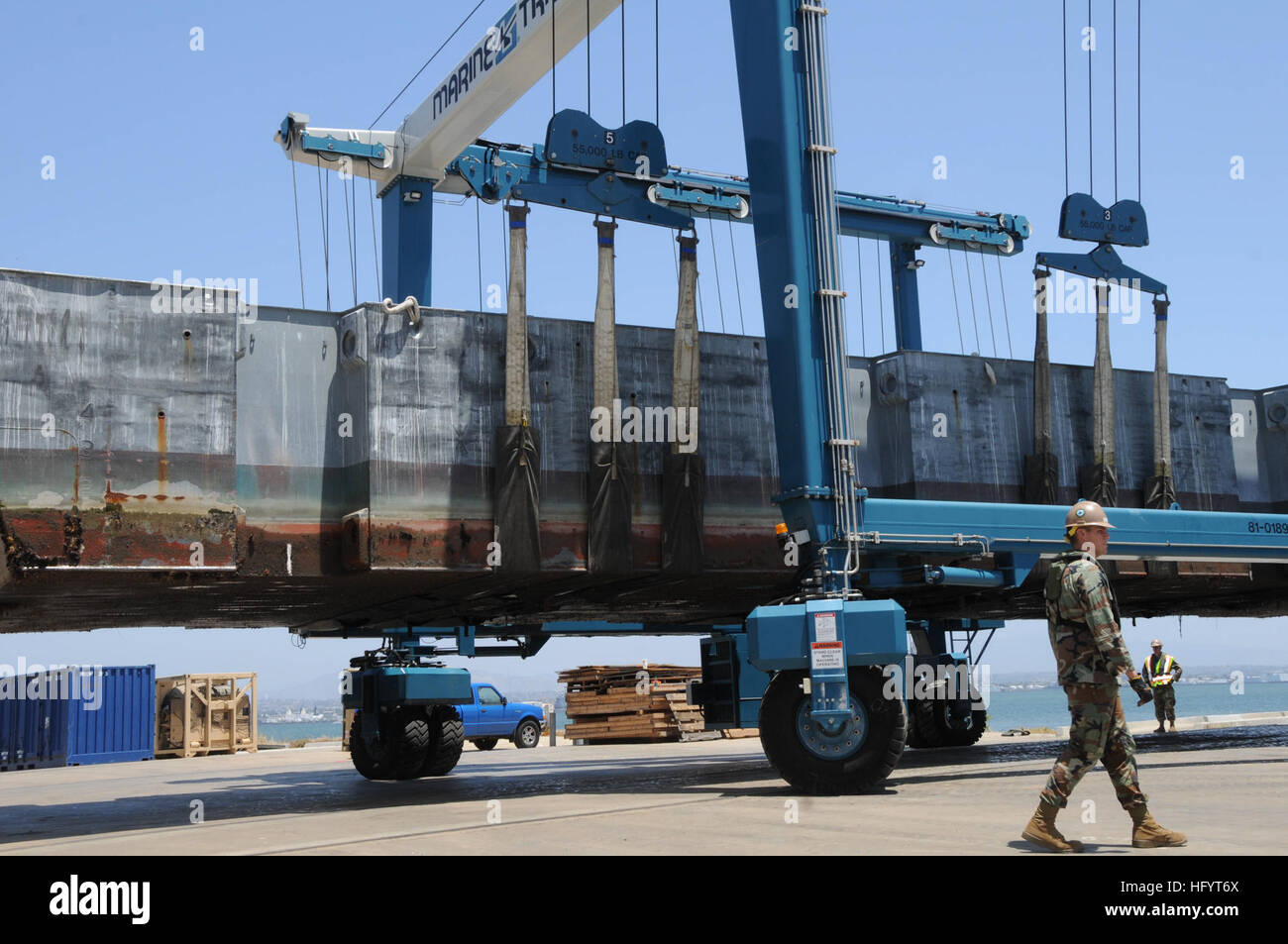 Seabees and Sailors from Amphibious Construction Battalion 1 lift a ...