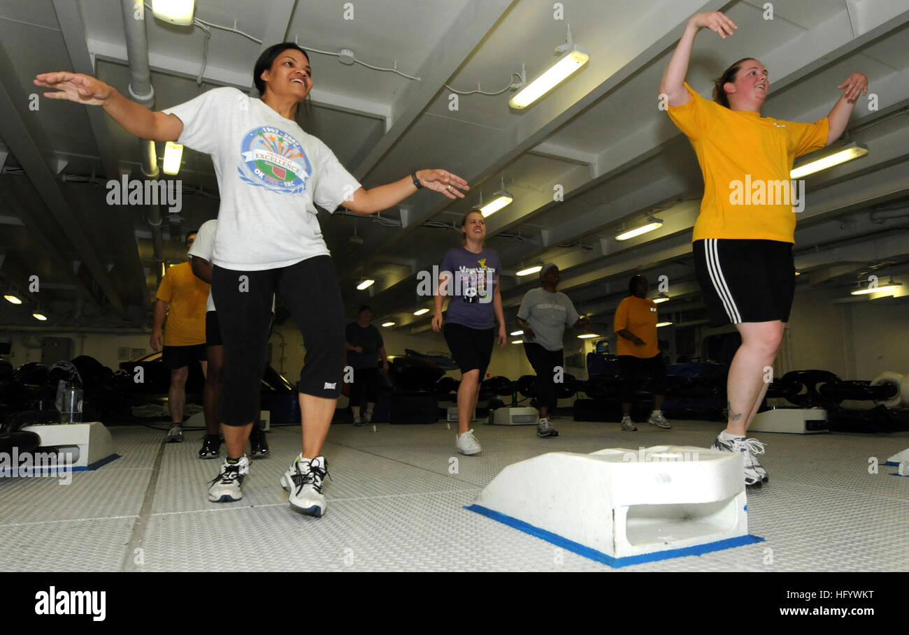 110621-N-QL471-152 GULF OF ADEN (June 21, 2011) Aviation Maintenance Administrationman 1st Class Brandi Heath, left, and Aviation Ordnanceman 2nd Class Tonia Devine participate in a Zumba class in the foc'sle aboard the aircraft carrier USS George H.W. Bush (CVN 77). George H.W. Bush is deployed supporting maritime security operations and theater security cooperation efforts in the U.S. 5th Fleet area of responsibility on its first overseas deployment. (U.S. Navy photo by Mass Communication Specialist 3rd Class Billy Ho/Released) US Navy 110621-N-QL471-152 Aviation Maintenance Administrationma Stock Photo