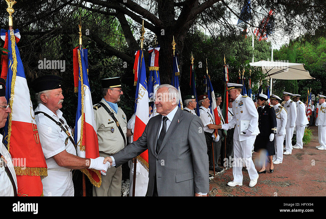 110704-N-AG285-236 CANNES, FRANCE (July 4, 2011) The mayor of Cannes, France, Bernard Brochand, shakes hands with official flag bearers during a memorial service honoring American pilots lost in a downed B-24 Liberator during World War II. Sailors and embarked Marines aboard Whidbey Island also attended to pay homage to their fallen service members. Whidbey Island is deployed as part of the Bataan Amphibious Ready Group, supporting maritime security operations and theater security cooperation efforts in the U.S. 6th fleet area of responsibility. (U.S. Navy photo by Mass Communication Specialis Stock Photo