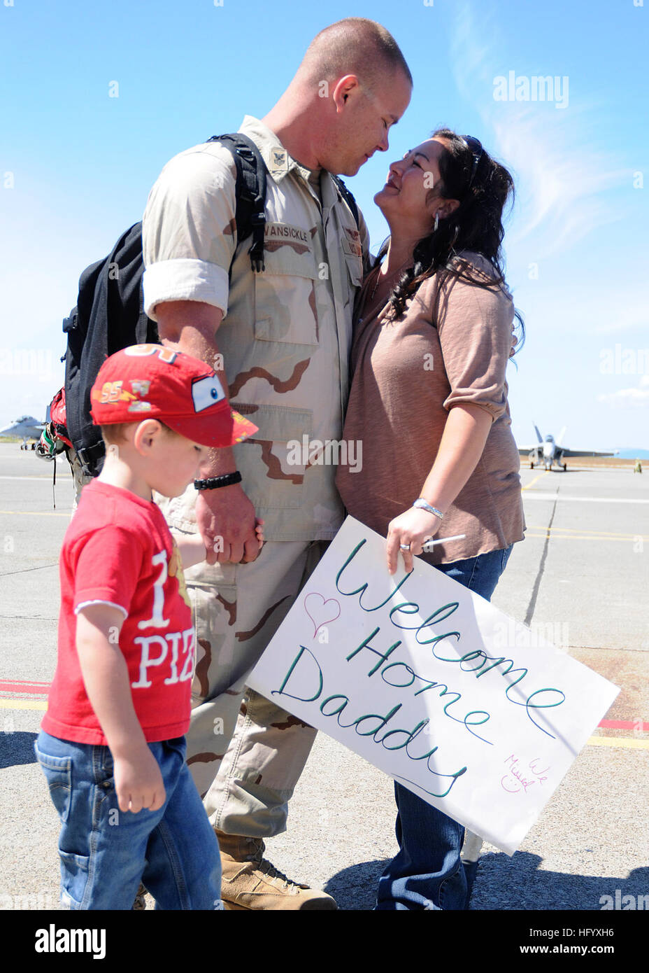 110709-N-ZK021-004 OAK HARBOR, Wash. (July 9, 2011) Aviation Structural Mechanic 1st Class Ry Vansickle, from Wichita, Kan., assigned to the Scorpions of Electronic Attack Squadron (VAQ) 132, is greeted by family during a homecoming ceremony at Naval Air Station Whidbey Island following an eight-month expeditionary deployment supporting Operation New Dawn and Operations Odyssey Dawn and Unified Protector. VAQ-132 protected numerous U.S. and Coalition military assets and personnel in the U.S. Central Command and U.S. European Command areas of responsibility. (U.S. Navy photo by Mass Communicati Stock Photo