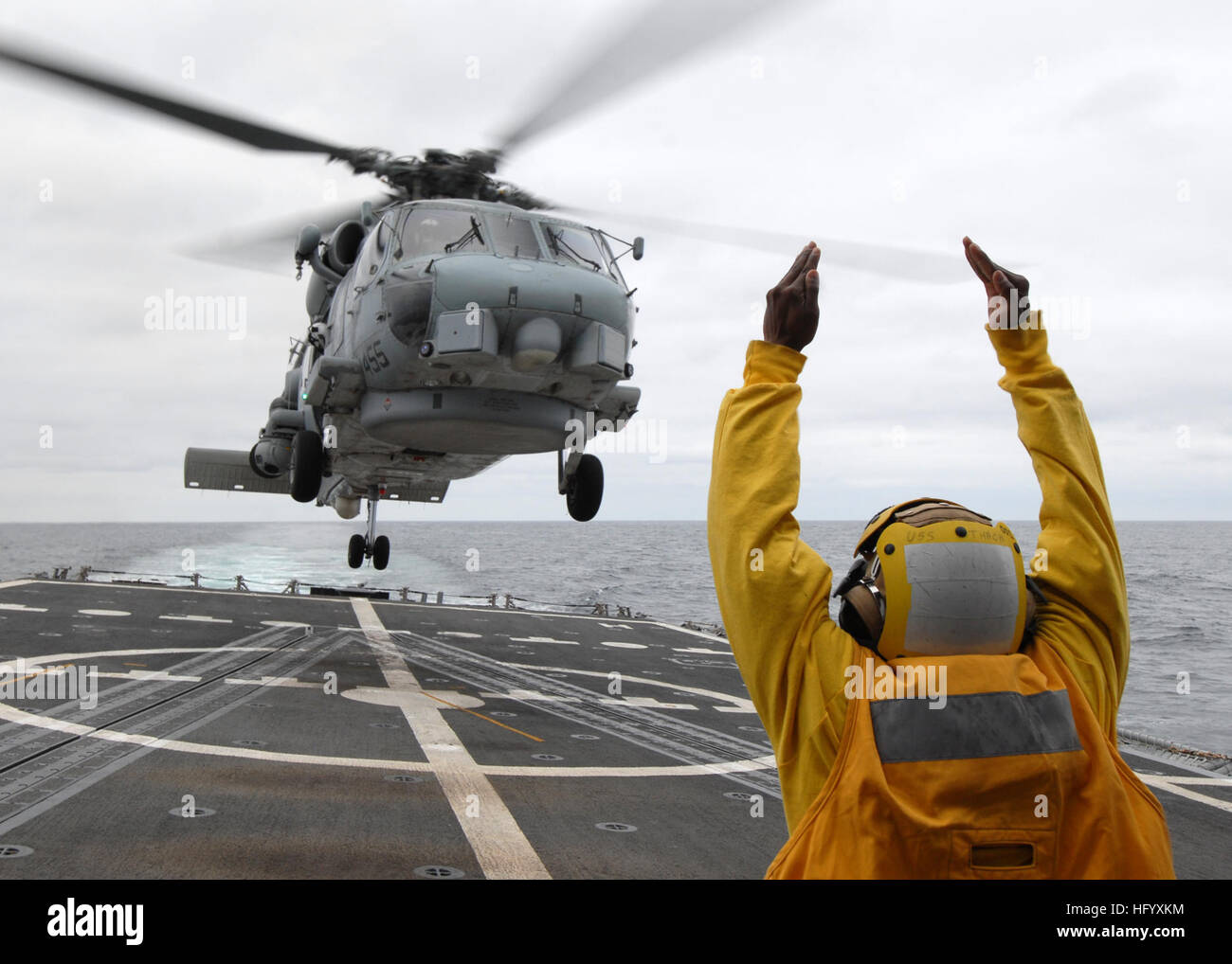 110711-N-ZI300-135 PACIFIC OCEAN (July 11, 2011) A landing signal enlisted signals to the pilots of an SH-60B Sea Hawk helicopter taking off from the guided-missile frigate USS Thach (FFG 43). The SH-60B Sea Hawk is assigned to Anti-Submarine Squadron Light (HSL) 44 and is embarked aboard USS Boone (FFG 28). Thach and Boone are deployed to South America supporting Southern Seas 2011. (U.S. Navy photo by Mass Communication Specialist 1st Class Steve Smith/Released) US Navy 110711-N-ZI300-135 A landing signal enlisted signals to the pilots of an SH-60B Sea Hawk helicopter taking off from the gui Stock Photo