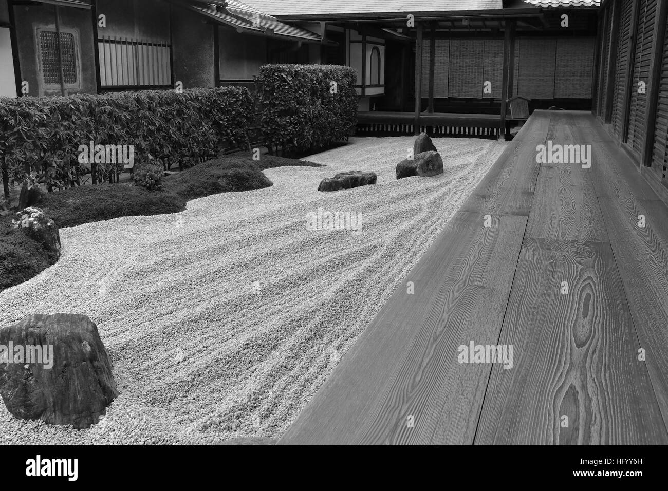 Zen garden in a characteristically Japanese setting in Kyoto, Japan.  A purposefully created dry landscape garden evoking serenity, peace, calmness. Stock Photo