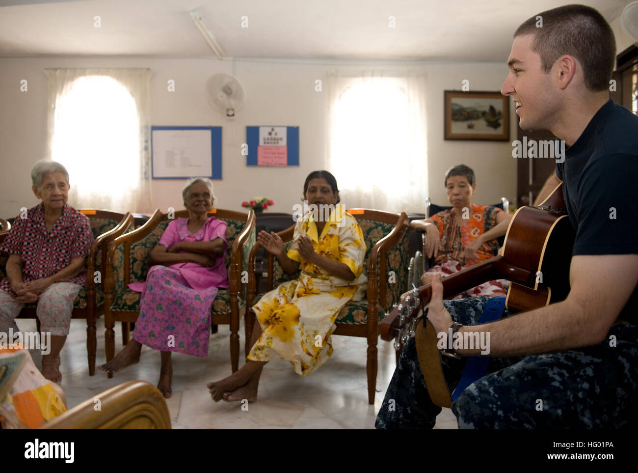 110907-N-JI215-048 KLANG, Malaysia (Sept. 7, 2011) Lt. Paul Oyler, from Paso Robles, Calif., performs worship songs for senior citizens at the Shekinah Senior Citizens Home in Klang, Malaysia, during a community service event. The John C. Stennis Carrier Strike Group is in Malaysia as part of a scheduled port visit during a deployment to the western Pacific Ocean and Arabian Gulf.  (U.S. Navy photo by Mass Communication Specialist 3rd Class Timothy Aguirre/Released) US Navy 110907-N-JI215-048 Lt. Paul Oyler performs worship songs for senior citizens at the Shekinah Senior Citizens Home in Klan Stock Photo