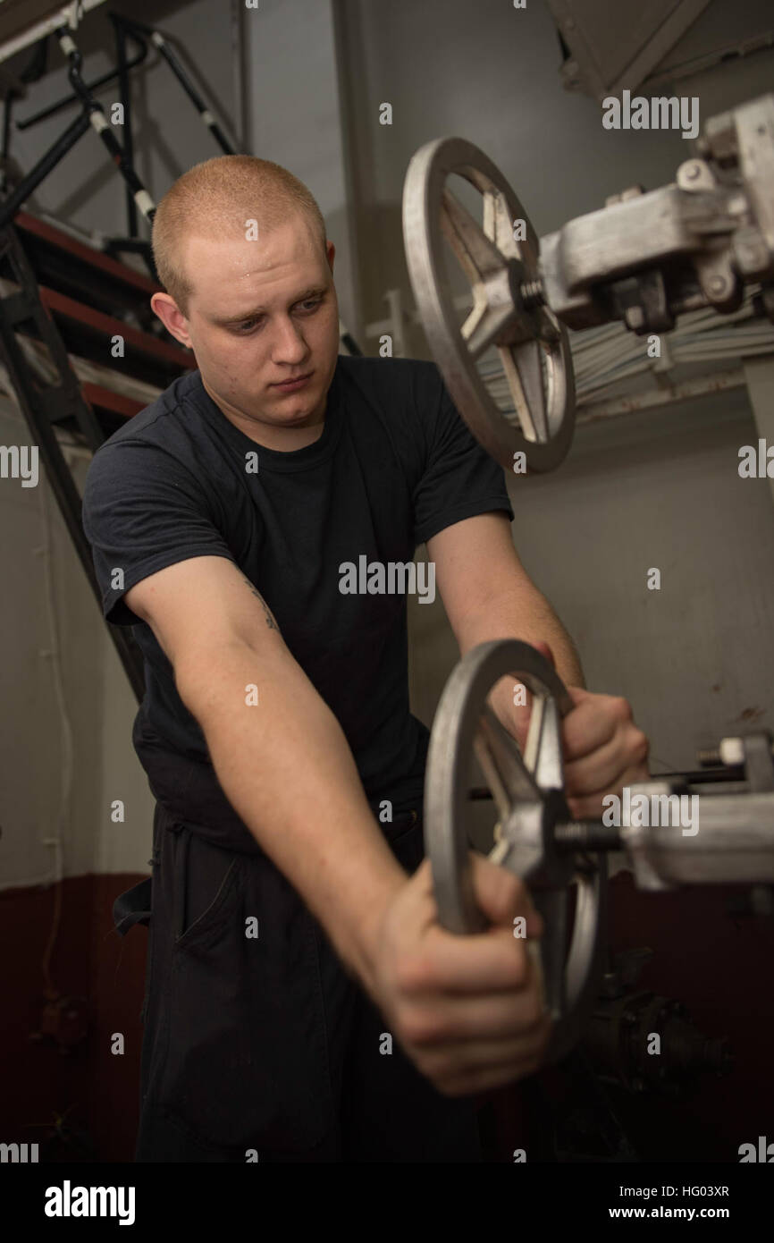 160823-N-WC455-058    ARABIAN GULF (Aug. 23, 2016) Machinist's Mate Fireman Alex Schuessler, from Pittsburgh, Pa., drains water from a reservoir in the number one reboiler space of the aircraft carrier USS Dwight D. Eisenhower (CVN 69) (Ike). Ike and its Carrier Strike Group are deployed in support of Operation Inherent Resolve, maritime security operations and theater security cooperation efforts in the U.S. 5th Fleet area of operations. (U.S. Navy photo by Mass Communication Specialist Seaman Joshua Murray) USS Dwight D. Eisenhower Deployment 160823-N-WC455-058 Stock Photo