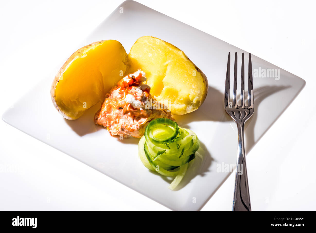 curd junket Quark preparation with steamed potatoes and cucumber  salad Stock Photo