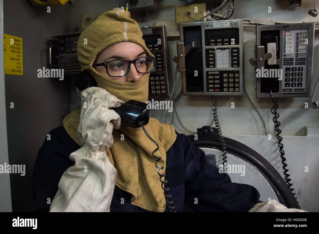161205-N-AY934-021  SASEBO, Japan (Dec. 5, 2016) Petty Officer 3rd Class Rosemary Carter establishes communications from Repair Locker 7 to Damage Control Central during a general quarters drill aboard amphibious assault ship USS Bonhomme Richard (LHD 6). Bonhomme Richard, forward-deployed to Sasebo, Japan, is serving forward to provide a rapid-response capability in the event of a regional contingency or natural disaster. (U.S. Navy photo by Petty Officer 2nd Class Naomi VanDuser/Released) USS Bonhomme Richard (LHD 6) General Quarters Drill 161205-N-AY934-021 Stock Photo