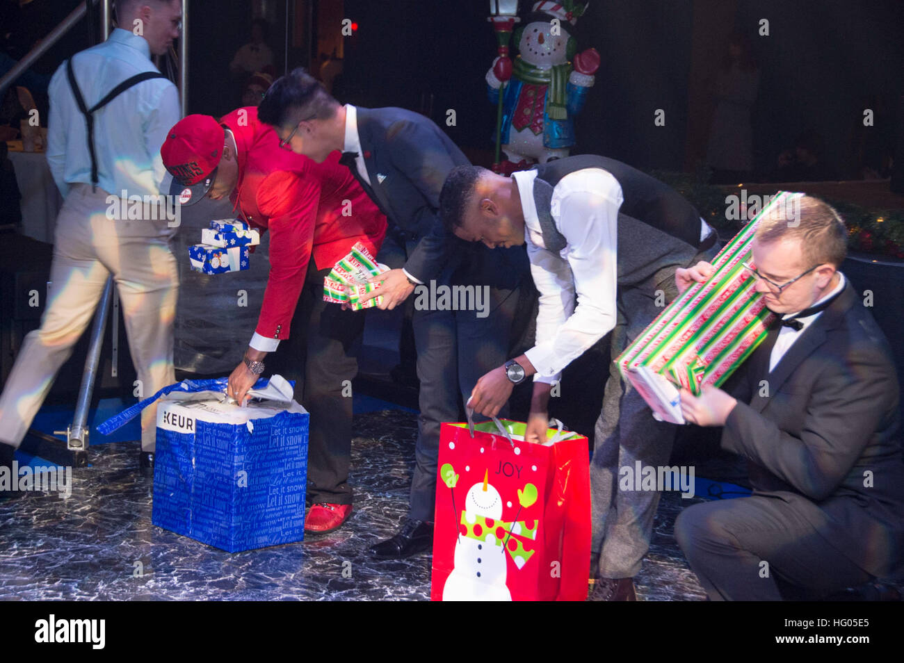 161208-N-XK809-593 SASEBO, Japan (Dec. 8, 2016) Sailors, assigned to amphibious assault ship USS Bonhomme Richard (LHD 6), open prizes won during a raffle drawing at a command holiday party. Bonhomme Richard, forward-deployed to Sasebo, Japan, is serving forward to provide a rapid-response capability in the event of a regional contingency or natural disaster. (U.S. Navy photo by Petty Officer 3rd Class William Sykes/Released) USS Bonhomme Richard (LHD 6) command holiday party 2016 161208-N-XK809-593 Stock Photo