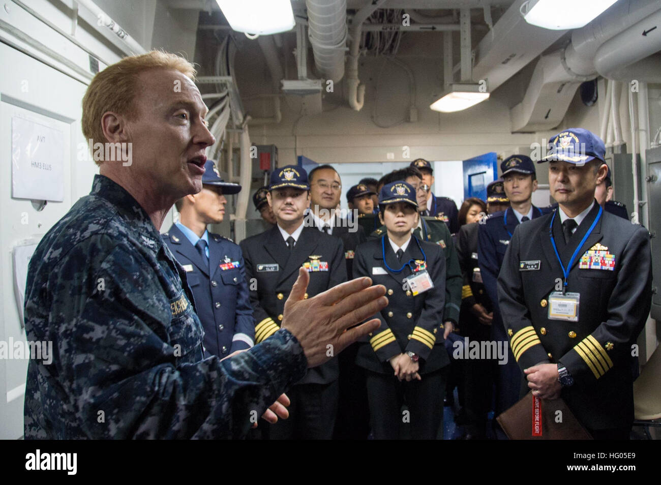 161208-N-AY934-103 SASEBO, Japan (Dec. 8, 2016) Capt. Kurt Eichenmuller, senior medical officer of amphibious assault ship USS Bonhomme Richard (LHD 6), discusses the capabilities of the ship’s medical facilities with officers from the Japan Self-Defense Force Joint Staff College during a ship’s tour. Bonhomme Richard, forward-deployed to Sasebo, Japan, is serving forward to provide a rapid-response capability in the event of a regional contingency or natural disaster. (U.S. Navy photo by Petty Officer 2nd Class Naomi VanDuser/Released) USS Bonhomme Richard (LHD 6) Japan Self-Defense Force Joi Stock Photo