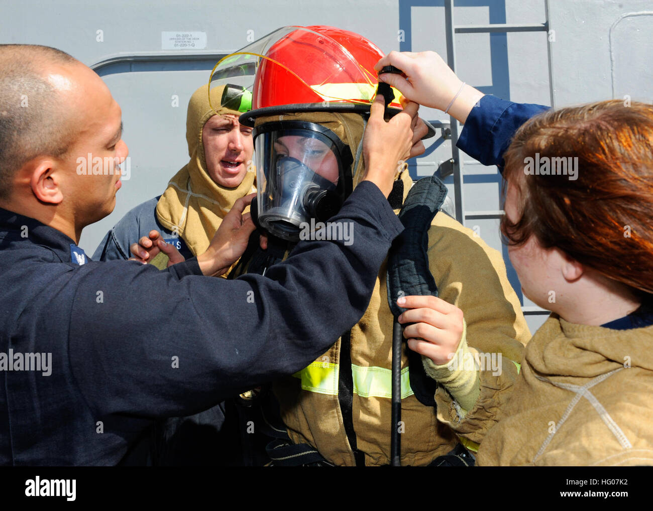 A damage control team aboard USS Wayne E. Meyer conducts a firefighting ...