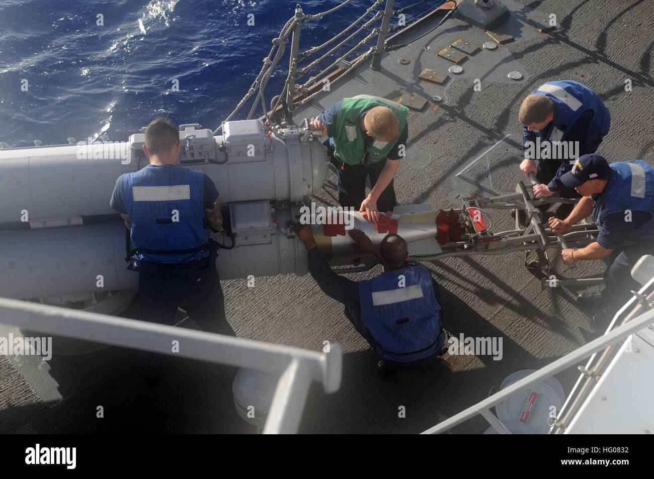 Sailors load a MK-46 torpedo aboard the Arleigh Burke-class guided ...