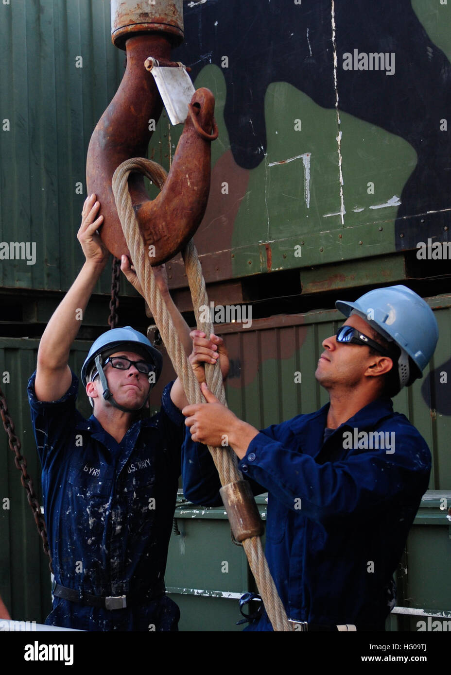 Sailors aboard USS Tortuga operate the ship's crane to offload Combat ...