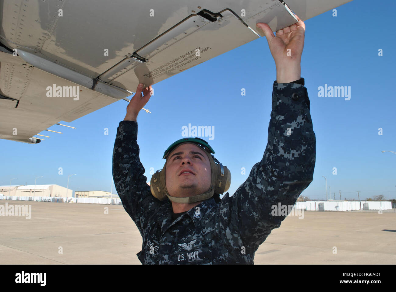 111207-N-GO535-115  FORT WORTH, Texas (Dec. 7, 2011) Aviation Machinist's Mate 2nd Class Ron Dischler, assigned to Fleet Logistics Support Squadron (VR) 59, inspects the aileron assembly of a C-9B Skytrain II aircraft on the tarmac at Naval Air Station Joint Reserve Base Fort Worth. Fleet logistics support squadrons operate on a worldwide basis to provide responsive, flexible, and rapid deployable air logistics support required to sustain combat operations at sea. (U.S. Navy photo by Mass Communication Specialist 2nd Class Ron Kuzlik/Released) US Navy 111207-N-GO535-115 Aviation Machinist's Ma Stock Photo