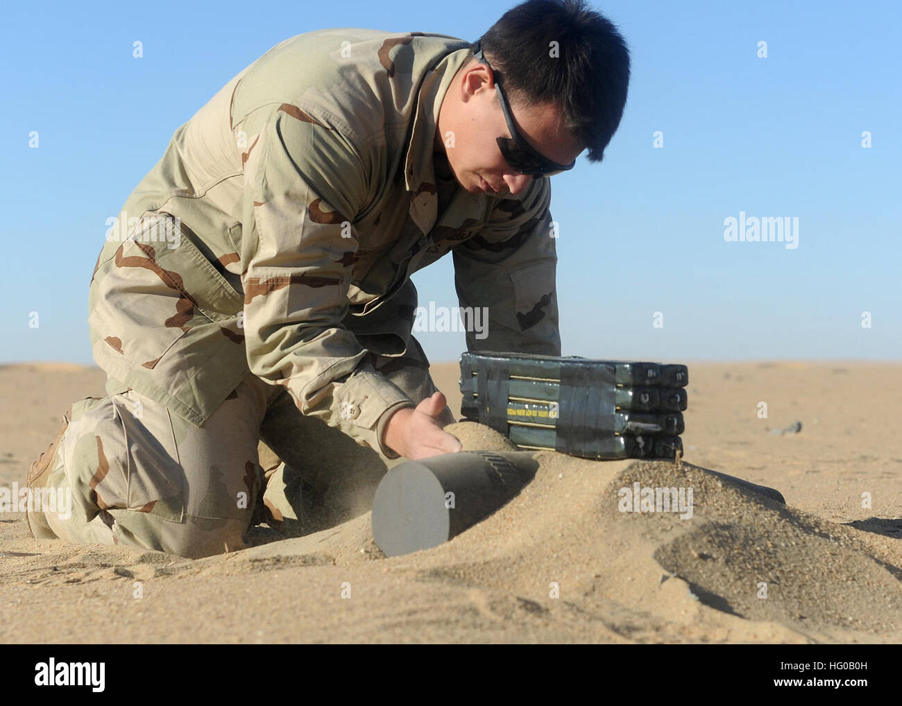 111213-N-BA263-569 CAMP BUEHRING, Kuwait (Dec. 13, 2011) Explosive Ordnance Disposal (EOD) Technician 2nd Class Reuban Villegas, assigned to Commander, Task Group (CTG) 56.1, places a composition C-4 demolition charge on a 155mm projectile during demolition operations supervisor training. CTG 56.1 provides mine counter-measure, explosive ordnance disposal, salvage-diving, counter-terrorism and force protection for the U.S. 5th Fleet area of responsibility. (U.S. Navy photo by Chief Mass Communication Specialist Kathryn Whittenberger/Released) US Navy 111213-N-BA263-569 Explosive Ordnance Dispo Stock Photo