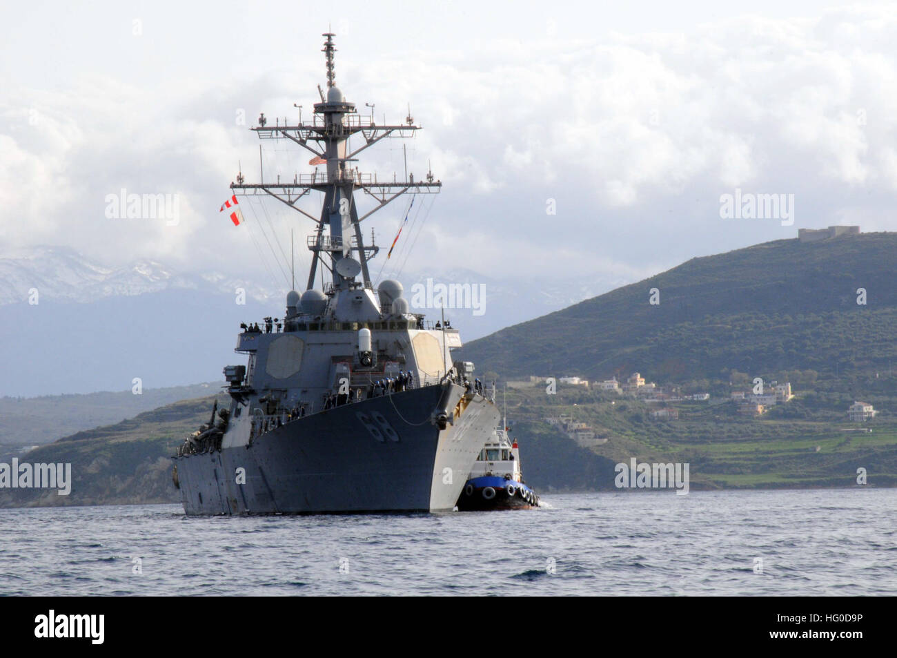 120124-N-ZB122-002 SOUDA BAY, Greece (Dec. 29, 2011) The Arleigh Burke-class guided-missile destroyer USS The Sullivans (DDG-68) is escorted by a tugboat to Marathi NATO Pier facility for a routine port visit. The Sullivans is operating in the U.S. 6th Fleet area of responsibility. (U.S. Navy photo by Mass Communication Specialist Seaman Chelsy Alamina/Released) US Navy 120124-N-ZB122-002 The Arleigh Burke-class guided-missile destroyer USS The Sullivans (DDG-68) is escorted by a tugboat to Marathi NATO Pie Stock Photo