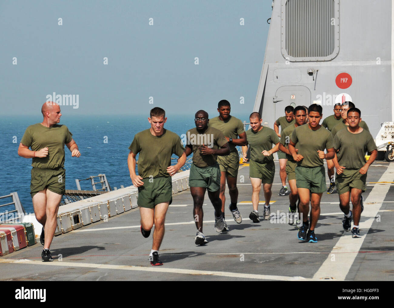 U.S. Marines from the 24th Marine Expeditionary Unit (24th MEU) conduct group physical training on the flight deck of the amphibious transport dock ship USS New York (LPD 21). New York is part of the Iwo Jima Amphibious Ready Group with the embarked 24th MEU and is deployed supporting maritime security operations and theater security cooperation efforts in the U.S. 5th Fleet area of responsibility. (U.S. Navy photo by Mass Communication Specialist 2nd Class Zane Ecklund/Released) USS New York 120706-N-NN926-009 Stock Photo