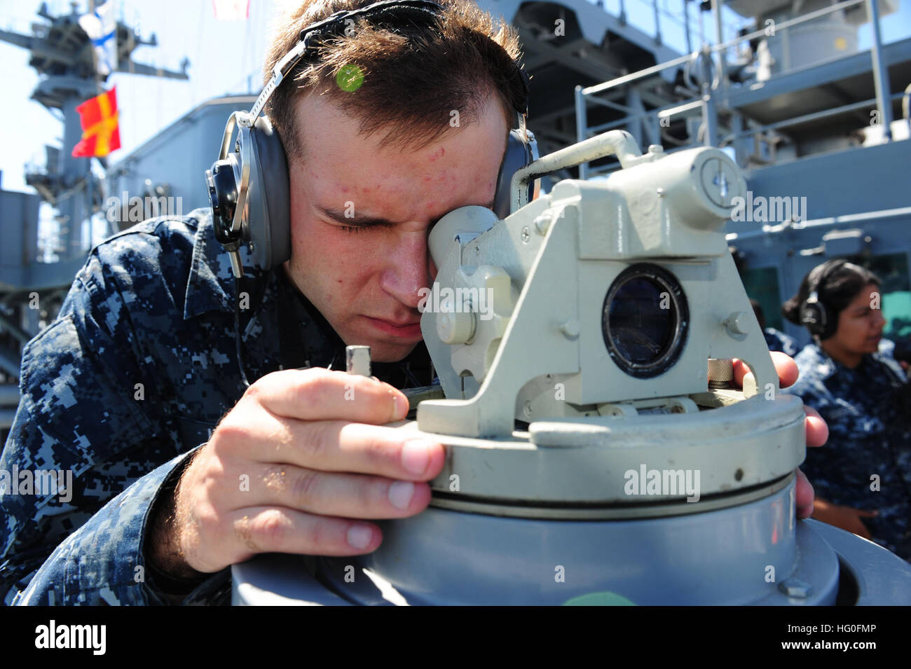 Quartermaster Seaman Braxton Klett from Madison, Iowa, reads ship's bearings from the bridge wing of the amphibious assault ship USS Boxer (LHD 4). Boxer is currently underway off the coast of Southern California. (U.S. Navy Photo by Mass Communication Specialist 3rd Class Maebel Tinoko/Released) USS Boxer sailors on deck 120827-N-UH966-007 Stock Photo