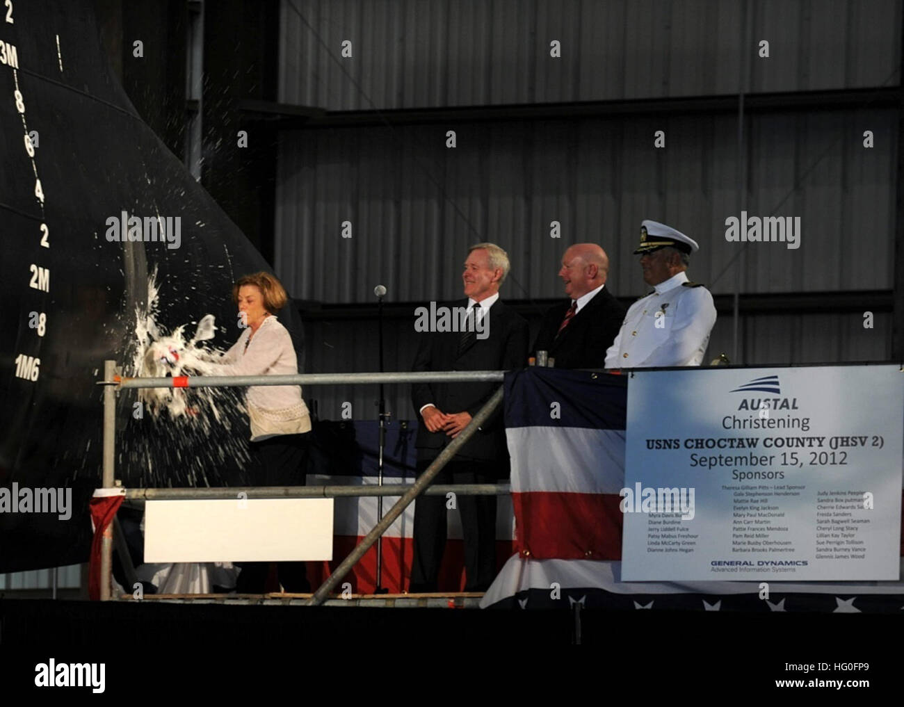 Theresa Gilliam Pitts, Sponsor of the Joint High Speed Vessel (JHSV) 2, USNS Choctaw County, breaks a bottle of champagne during the christening at  the Austal Shipyard. Secretary of the Navy Ray Mabus named the ship after three U.S. counties located in Mississippi, Alabama and Oklahoma; places he said demonstrate core American values of hard work, putting family first, and community service. (U.S. Navy photo by Chief Mass Communication Specialist Sam Shavers/Released) USNS Choctaw County christening 120915-N-AC887-002 Stock Photo