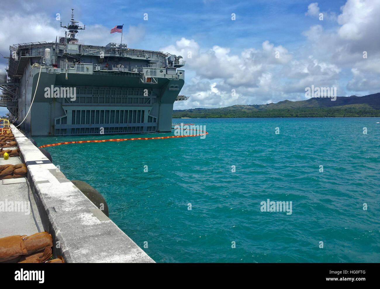 The forward-deployed amphibious assault ship USS Bonhomme Richard (LHD 6) is moored pierside at Naval Base Guam for a scheduled port visit. Bonhomme Richard, commanded by Capt. Daniel Dusek, is the lead ship of the only forward-deployed amphibious ready group and is currently operating in the 7th Fleet Area of Operations. (U.S. Navy photo by Mass Communication Specialist 2nd Class Michael Russell) USS Bonhomme Richard in Guam 120927-N-KB563-001 Stock Photo