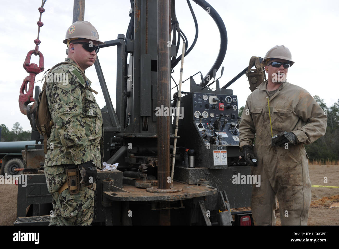U.S. Navy Steelworker 3rd Class Kristopher Poehl, left, and Construction Electrician 2nd Class Joel Shriver, both assigned to Naval Mobile Construction Battalion (NMCB) 15, operate a water well during pre-deployment training Jan. 8, 2013, at Camp Shelby, Miss. NMCB-15 was preparing to deploy to Afghanistan in support of Operation Enduring Freedom. (U.S. Navy photo by Mass Communication Specialist 2nd Class Daniel Garas/Released) Well operation 130108-N-OV434-011 Stock Photo