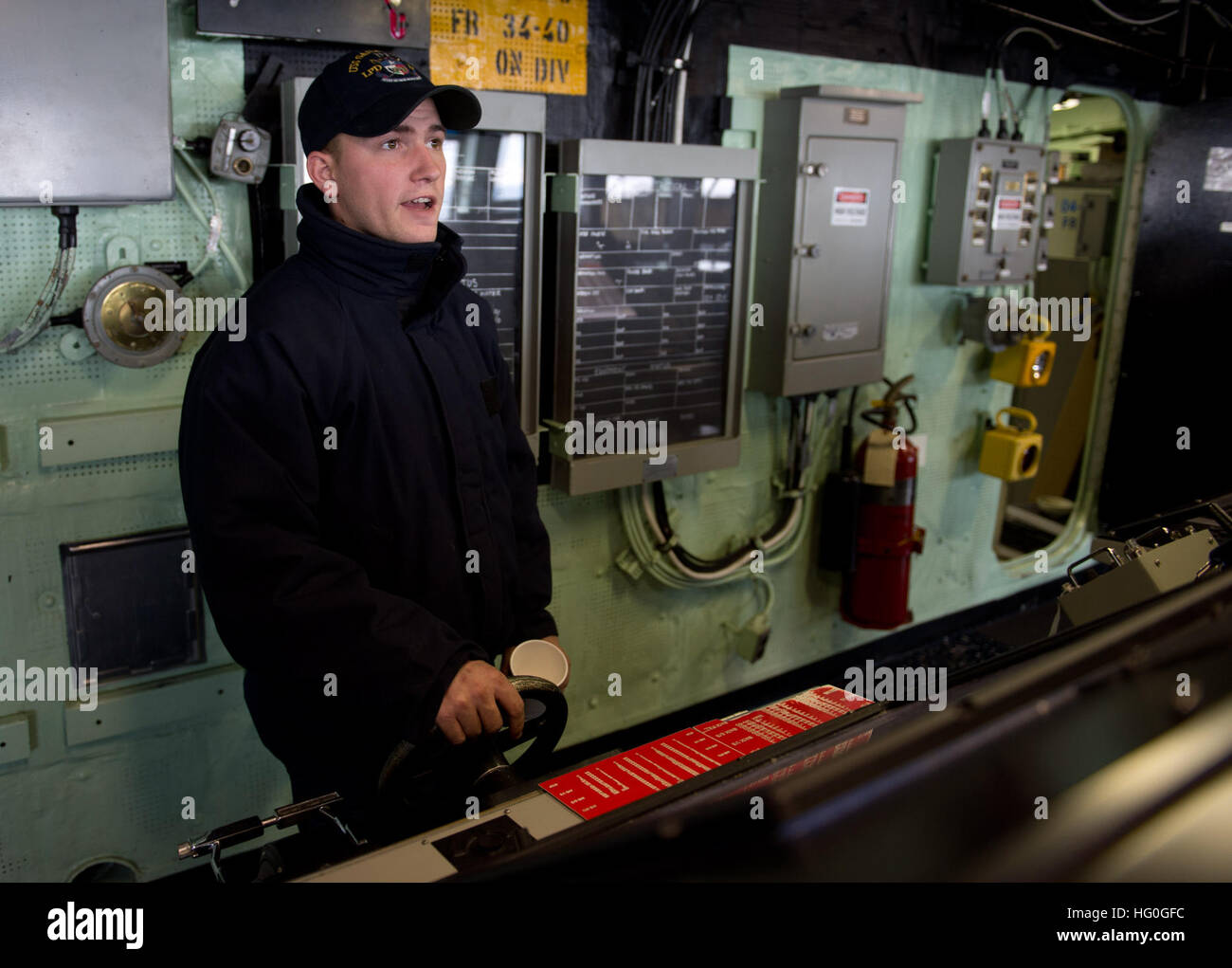Boatswain's Mate 3rd Class Richard Mattern stands the helmsman watch on