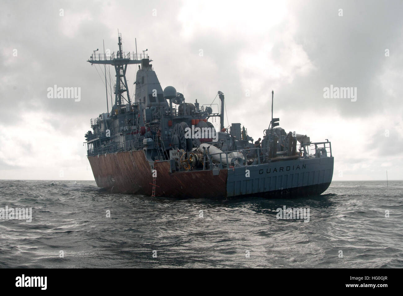 SULU SEA (Feb. 8, 2013) The mine countermeasures ship USS Guardian (MCM 5) sits aground on Tubbataha Reef. Since the Jan. 17 grounding, the U.S. Navy has worked in close cooperation with Philippine authorities to minimize environmental effects while developing a plan to safely remove Guardian from the reef. With the deteriorating integrity of the ship, the weight involved, and where it has grounded on the reef, the determination has been made that dismantling the ship in sections is the only supportable salvage option. The U.S. Navy continues to work closely with the Philippine Coast Guard as Stock Photo