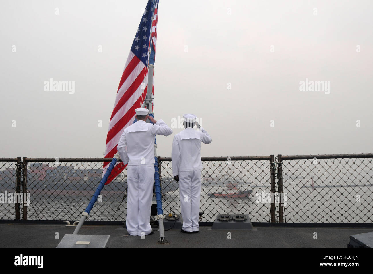 130616-N-NN332-032 JAKARTA, Indonesia (June 16, 2013) -- Electronics Technician 2nd Class Anthony Lehman, left, and Logistics Specialist 3rd Class Konadu Amopoku salute the national ensign during morning colors aboard U.S. 7th Fleet flagship USS Blue Ridge (LCC 19).  Blue Ridge port visits represent an opportunity to promote peace and stability in the South Indo-Asia-Pacific region, demonstrate commitment to regional partners and foster growing relationships. (U.S. Navy photo by Mass Communication Specialist 3rd Class Jared Harral/Released) USS Blue Ridge visit 130616-N-NN332-032 Stock Photo