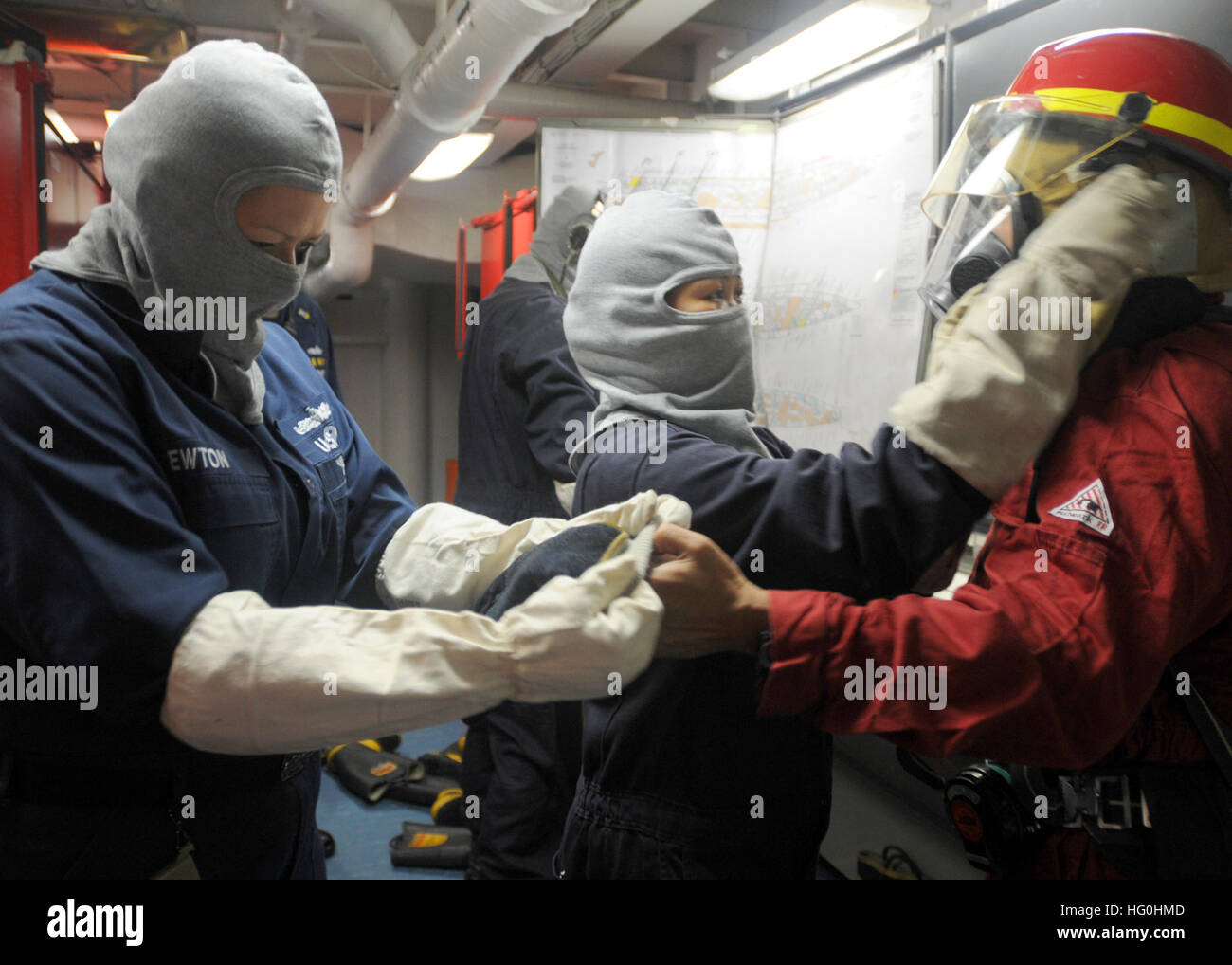 Sailors aboard USS Blue Ridge (LCC 19) assist a fellow Sailor with ...