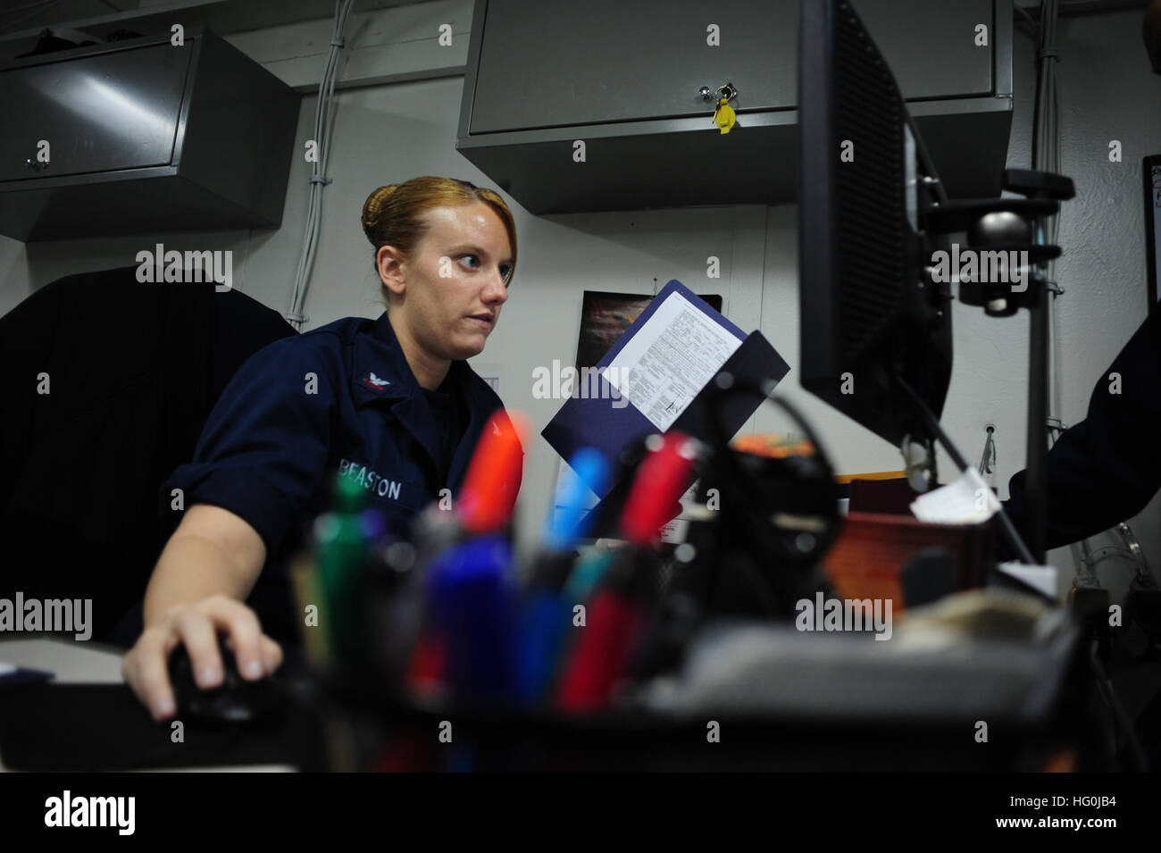 Yeoman 2nd Class Meghan Beaston checks her computer in the administration office aboard the amphibious assault ship USS Boxer (LHD 4). Boxer is deployed in the U.S. 7th Fleet area of responsibility conducting maritime security operations and theater security cooperation efforts as part of the Boxer Amphibious Ready Group. (U.S. Navy photo by Mass Communication Specialist 3rd Class Brian Jeffries/Released) USS Boxer operations 130909-N-SV688-043 Stock Photo