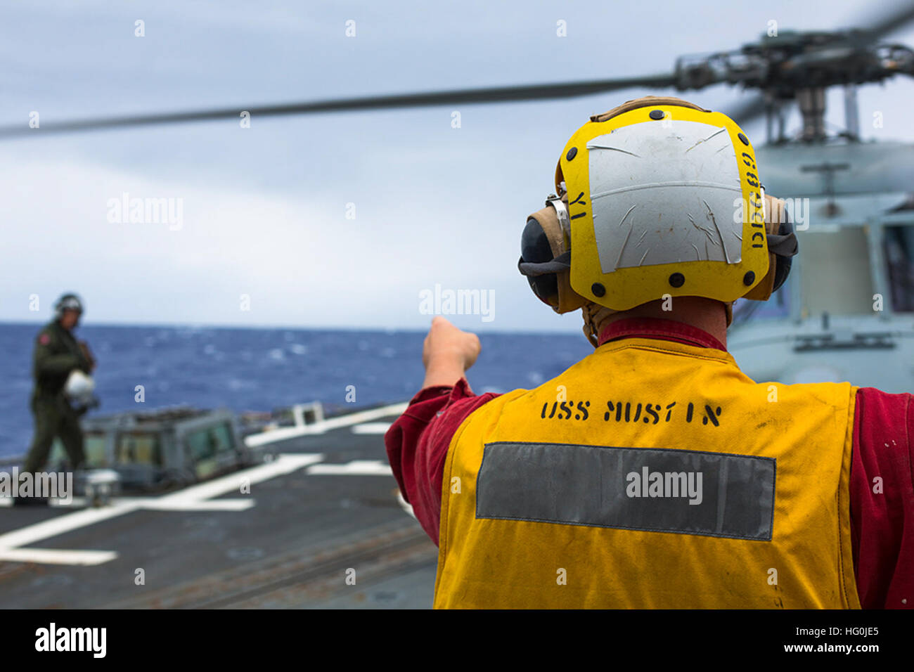 U.S. Navy Boatswain?s Mate Third Class Robert Barnes signals a Sailor
