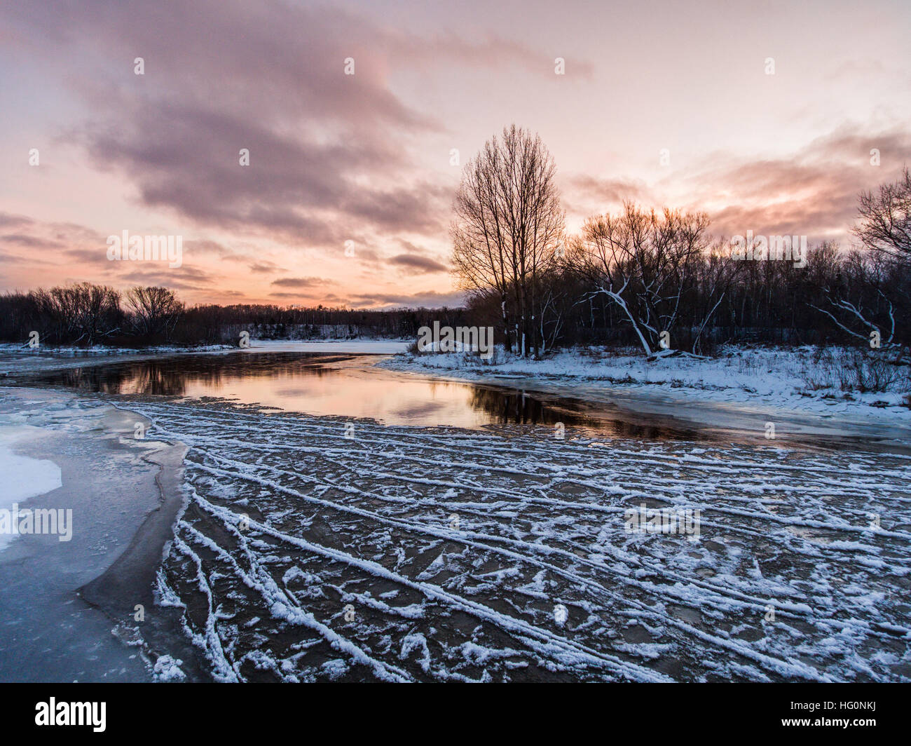Sunset over the freezing river Stock Photo